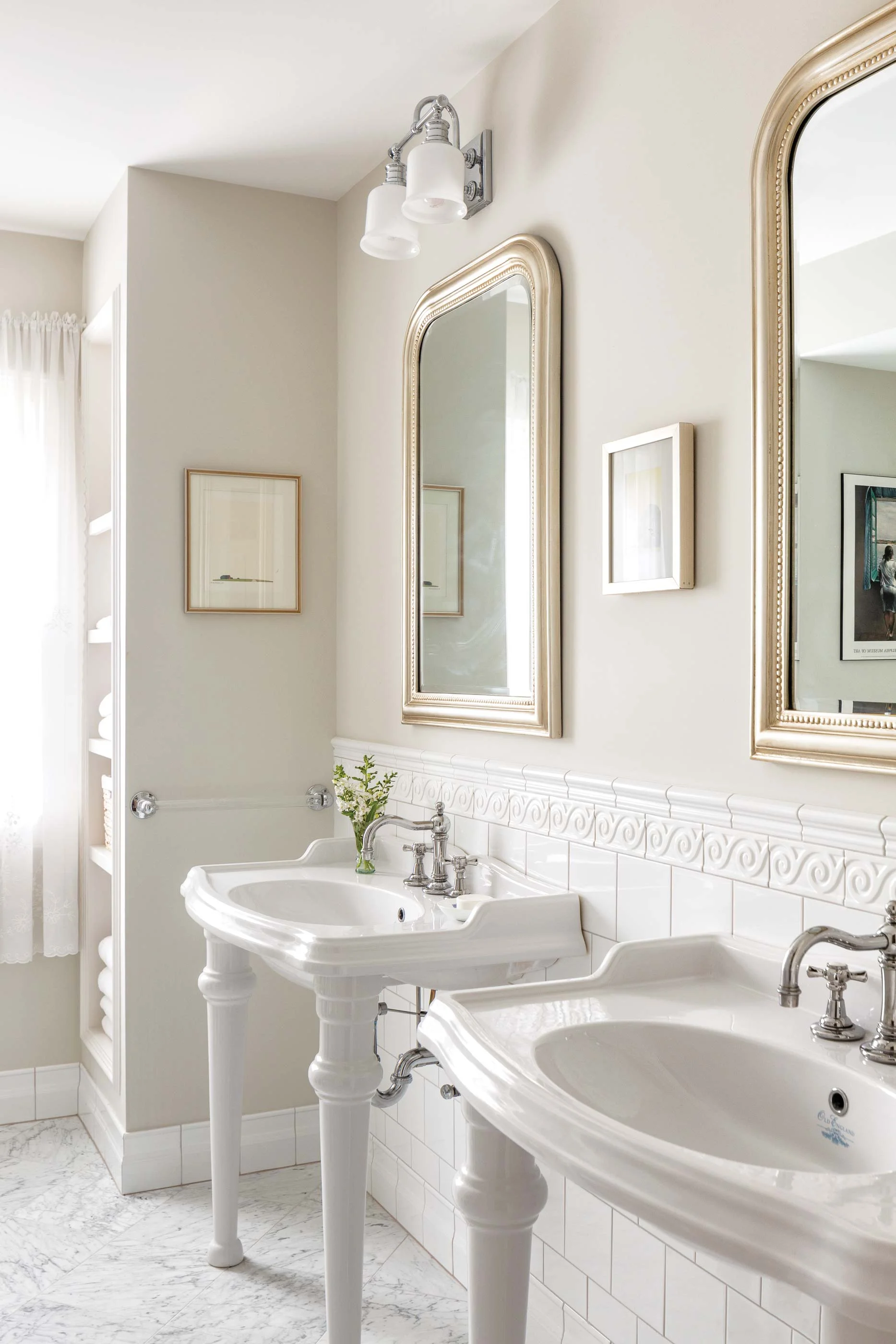 In the bathroom designed for the Ethridges’ daughter, Elizabeth Ethridge McGann, the twin sinks are from Homeperfect.com. The Swiss lace curtains in the window once hung in Seaward, the house of Helen McIntyre, Will’s grandmother.