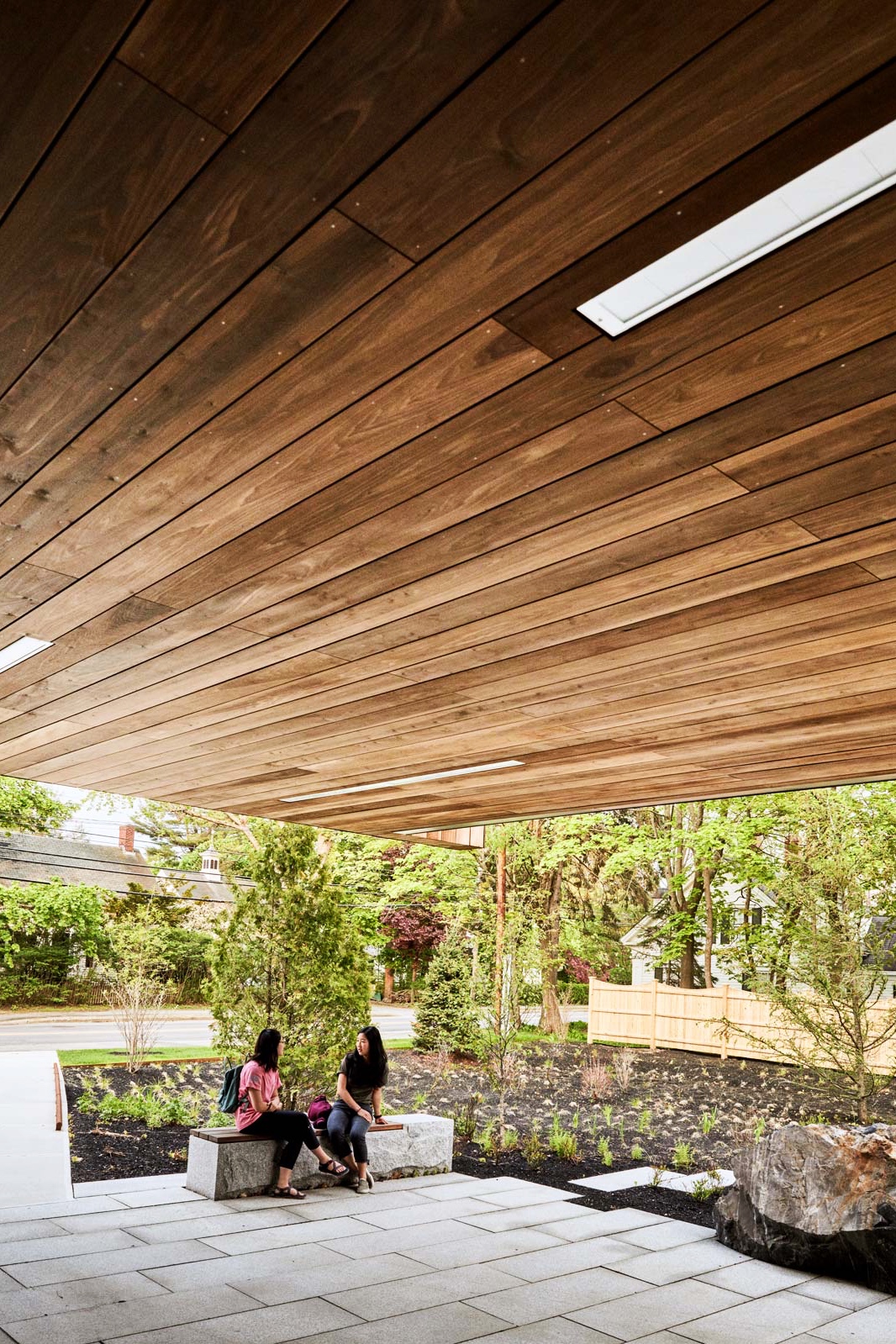 A terrace at the rear of the building offers a space to convene outdoors, while the flagstones and garden bed help to prevent stormwater runoff.