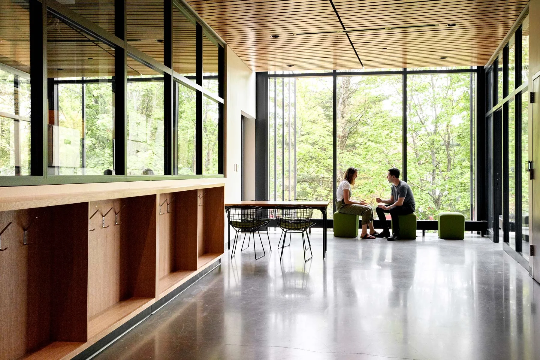 The building was positioned intentionally with windows to the south and north to capitalize on peak daylight hours. Here, a shot of the windows on the third floor shows the abundance of natural light and treetop views.