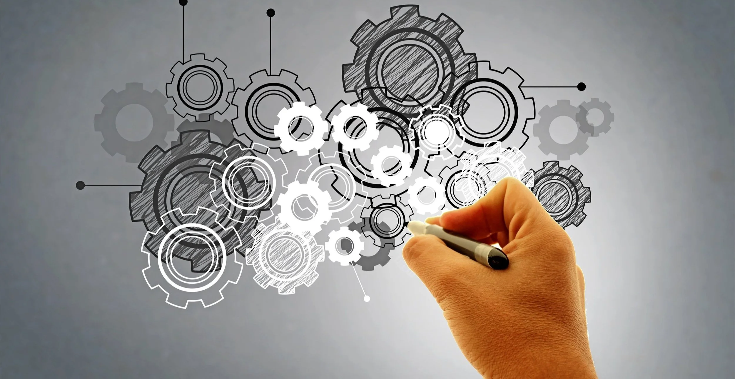 stockvault-hand-drawing-virtual-cogwheels-work-and-engineering-concept214452.jpg