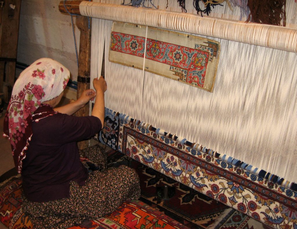 Turkish weaver creating a traditional rug
