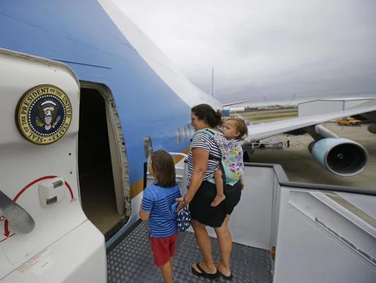 In this Monday, Sept. 18, 2017 photo Alysia Palmisciano along with two of her children, Riley Palmisciano-Wright, 6, and Reagan Palmisciano-Wright, 18 months, walk into the front hatch of the "Air Force One Experience," a full-sized 747 replica of Air Force One which is now open to the public in North Kingstown, R.I. (AP Photo/Stephan Savoia) Stephan Savoia