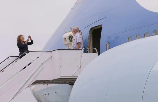 In this Monday, Sept. 18, 2017 photo Julia More photographs Christopher Jenkins as he stands just outside of the front hatch of the "Air Force One Experience," a full-sized 747 replica of Air Force One which is now open to the public in North Kingstown, R.I. (AP Photo/Stephan Savoia) Stephan Savoia