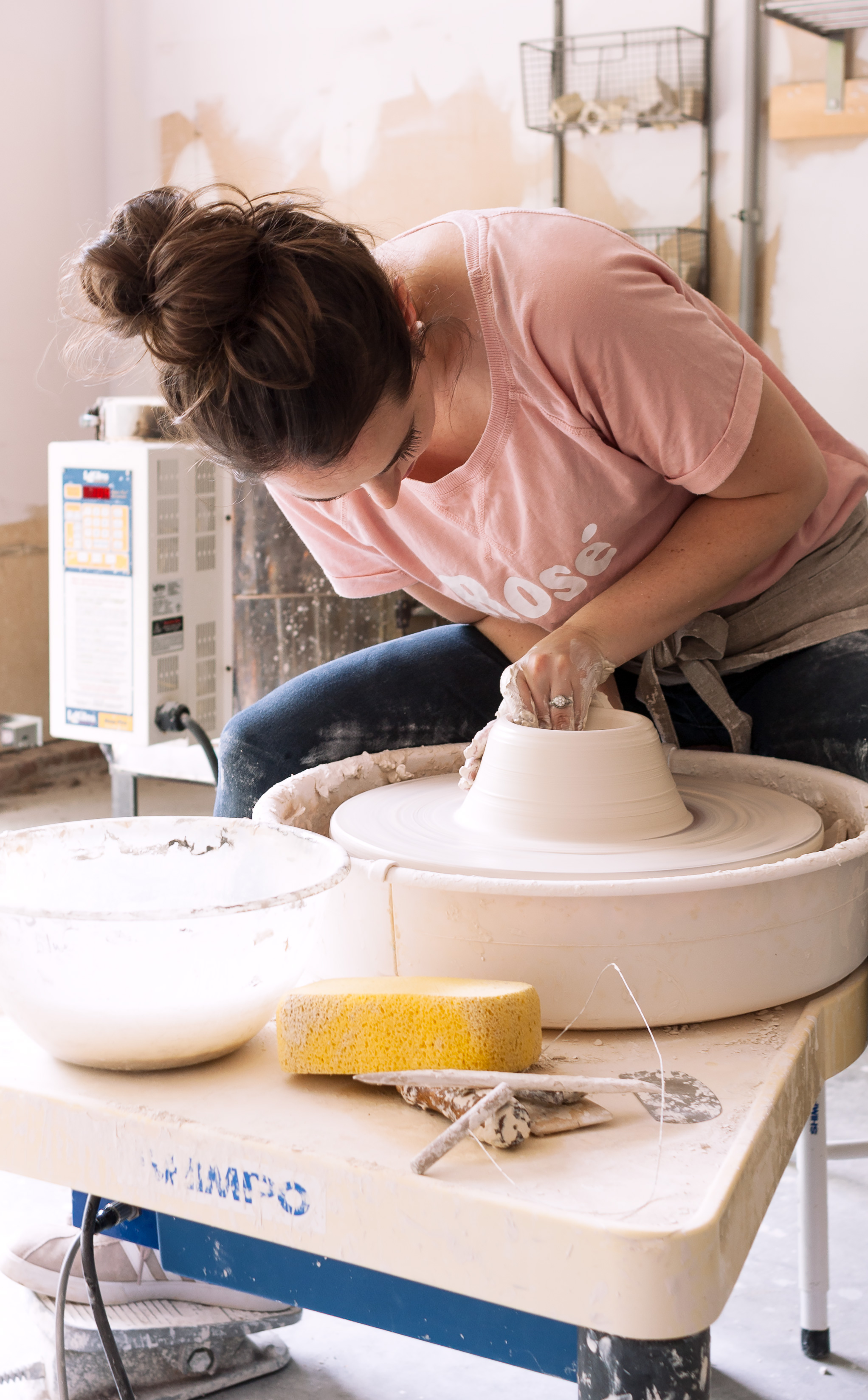 On my wheel throwing in my garage studio. I worked in this studio from Spring 2016 until Winter 2018. There was no running water, heat or AC but that didn’t matter! It was such an upgrade from the guest room and basement studios I’d previously had in my rental homes!