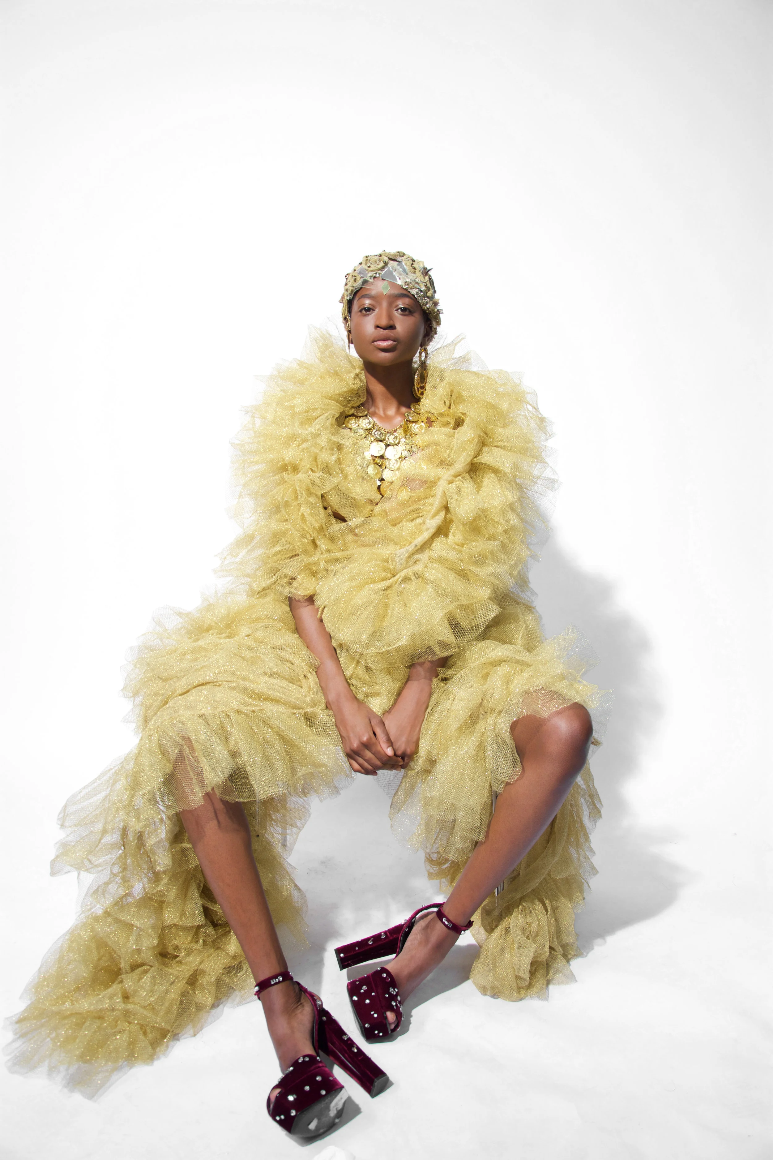 Keli is wearing Golden Tulle dress with applications by Filippo La Terza embroedery cup by Helion private collection golden medal necklace by hearing by accessorize shoes by Giuseppe Zanotti
