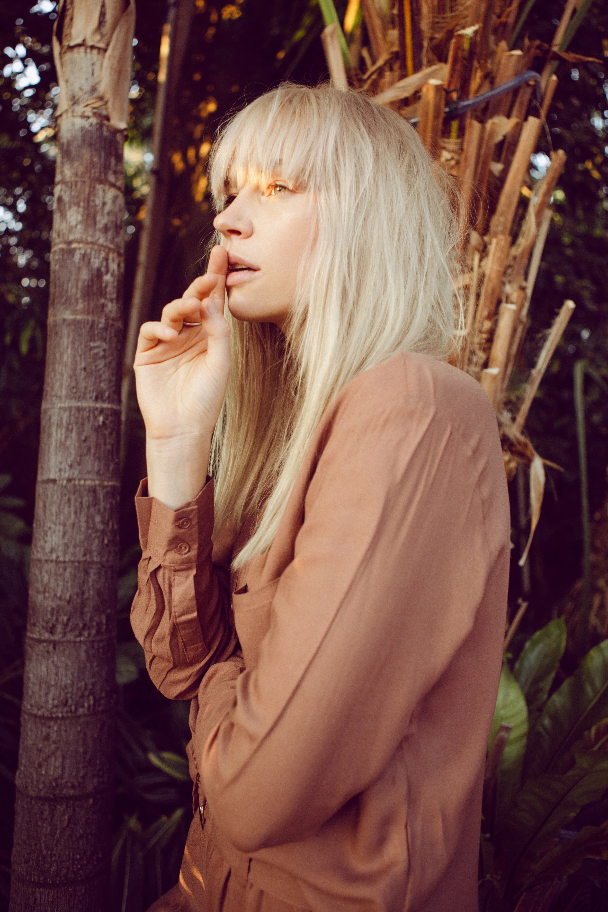 Rusted brown silk shirt: Milk Copenhagen Rings: Pierre Estienne