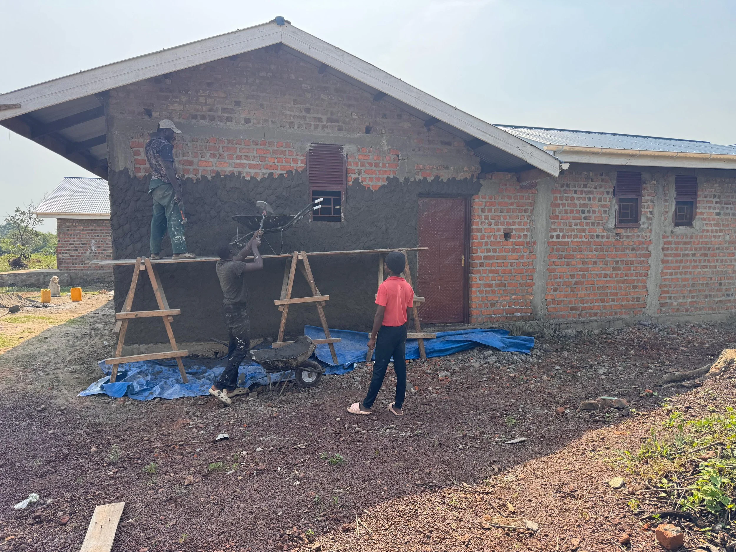 The team working hard plastering the exterior walls.