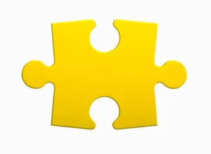 Closeup of jigsaw puzzle piece isolated on white