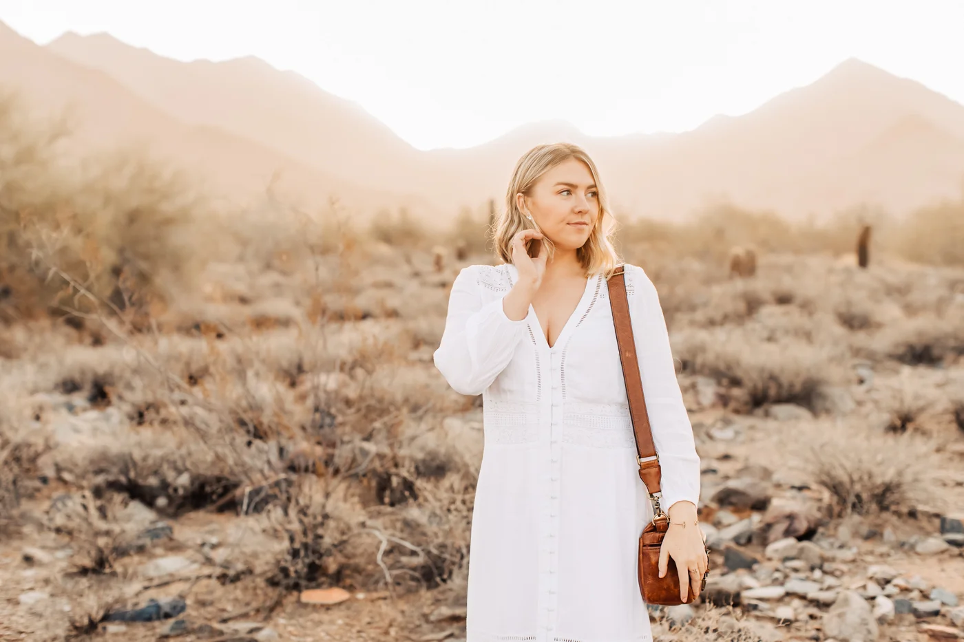 Wearing a white dress in the desert at sunrise.