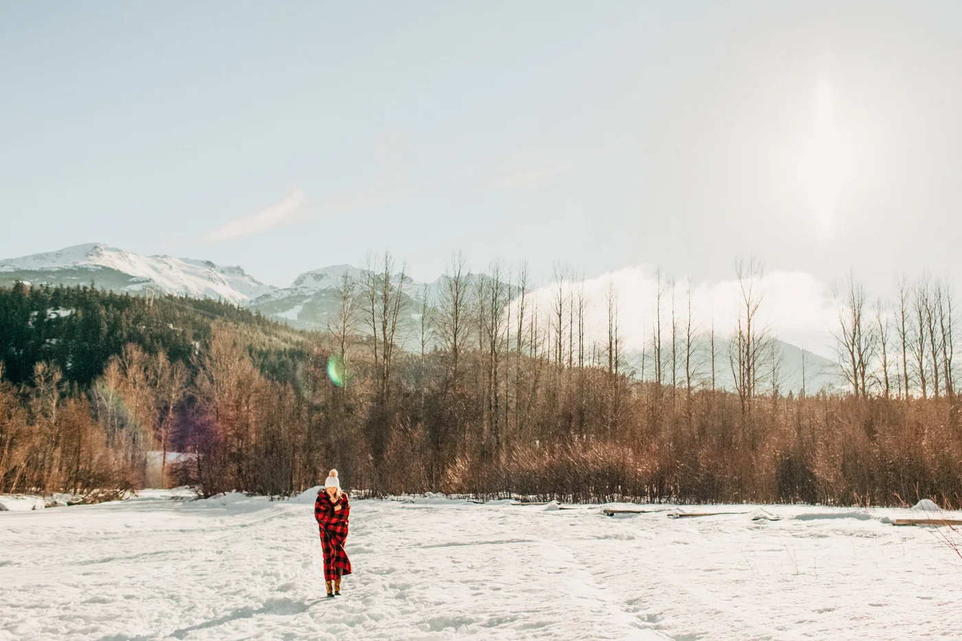 Bundled up in a blanket in the winter snow in Whistler, BC