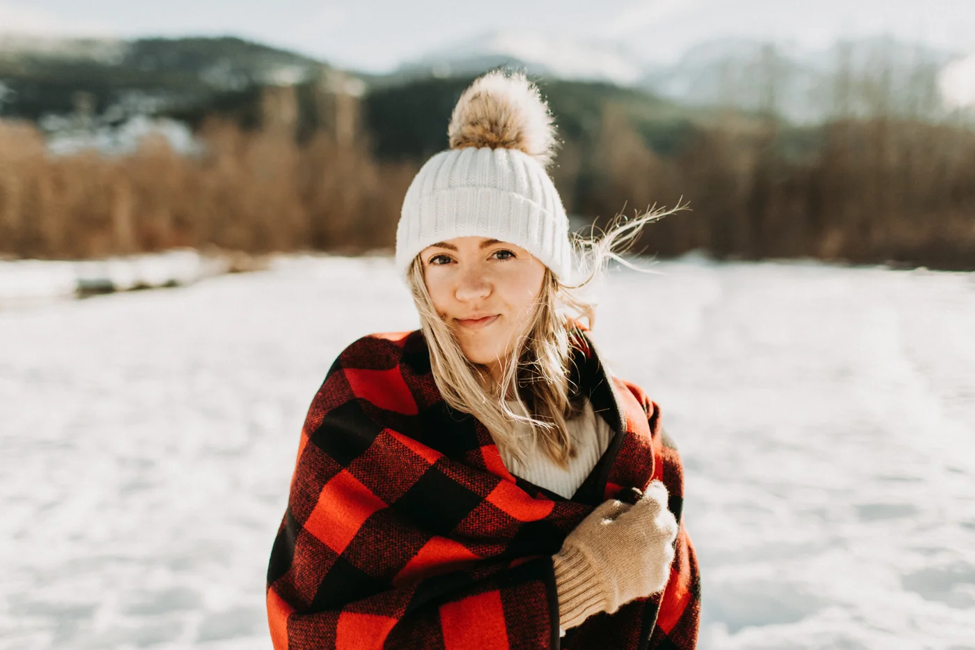 Bundled up in a blanket in the winter snow in Whistler, BC