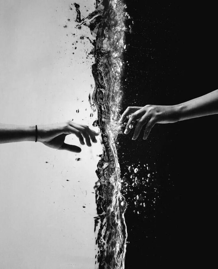 Hands reaching across water