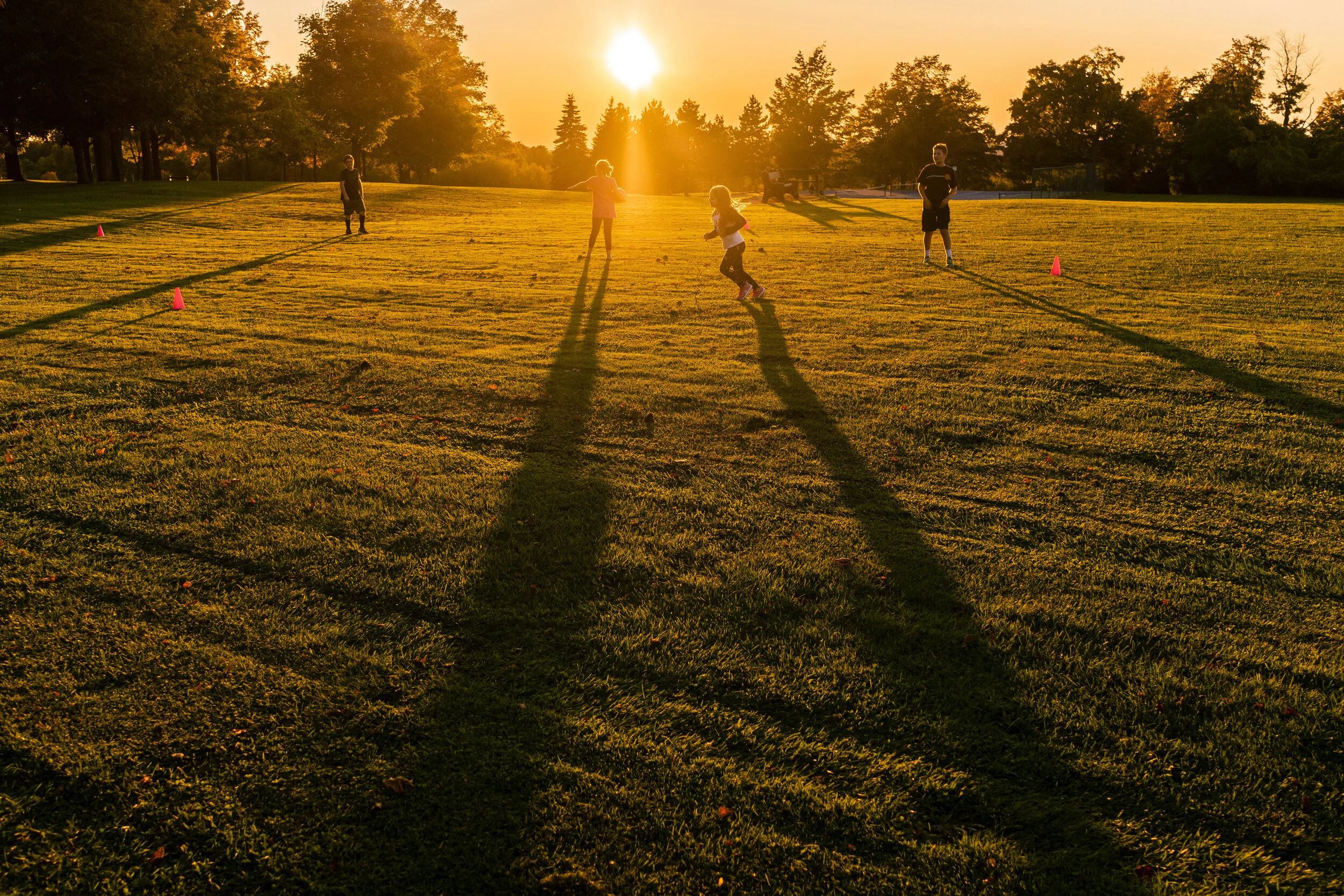  Long shadows stretch across the field as, from left to right, Connor Lamica, 10, Flora Bates, 9, Kate Lamica, 6, and Nicolas Bates, 12, play kickball at Thompson Park in Watertown, NY. 