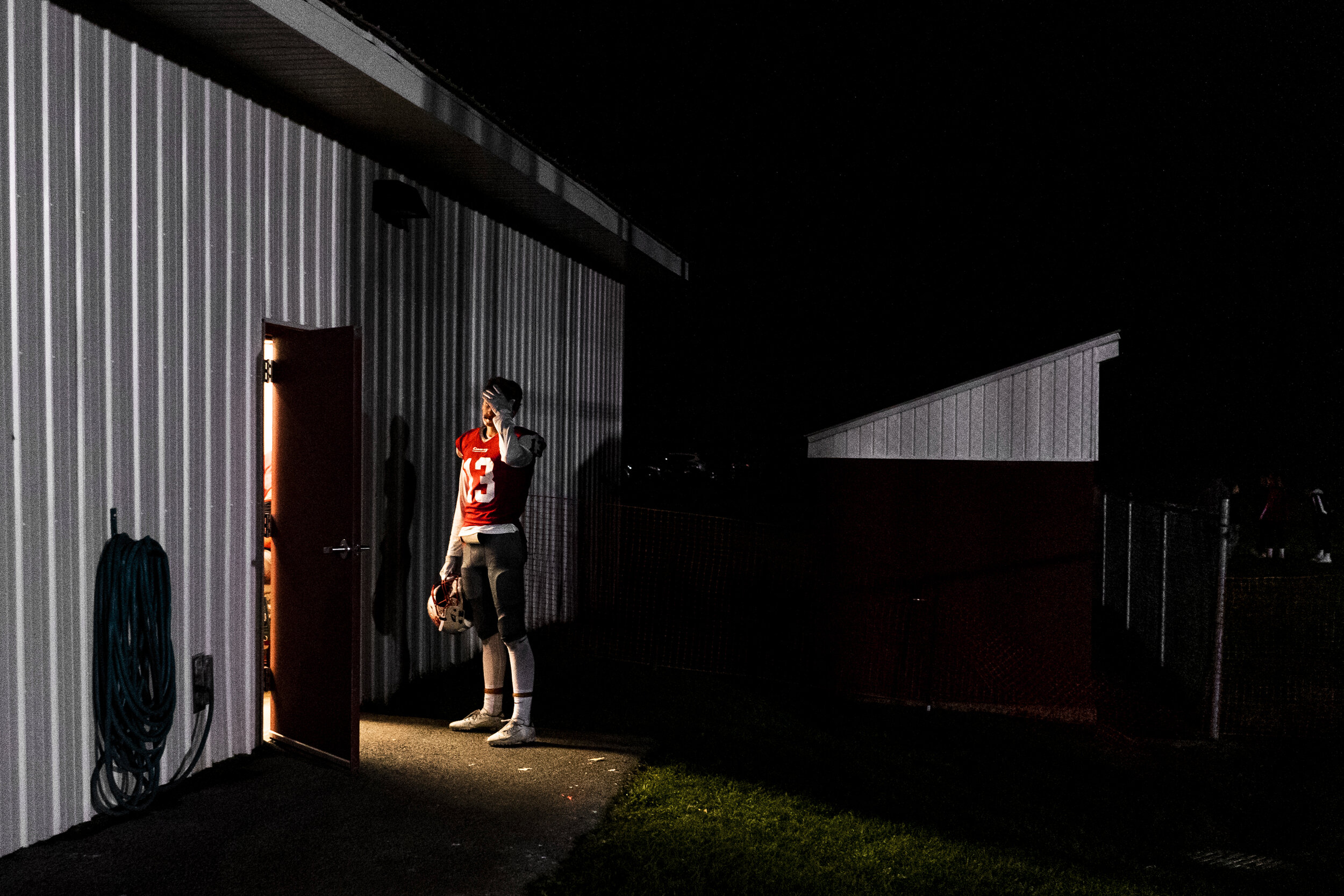  Thomas Albright, of Carthage Football, steps into the beam of light from the open door of the locker room during halftime of their game against Indian River at home in Carthage, NY. 