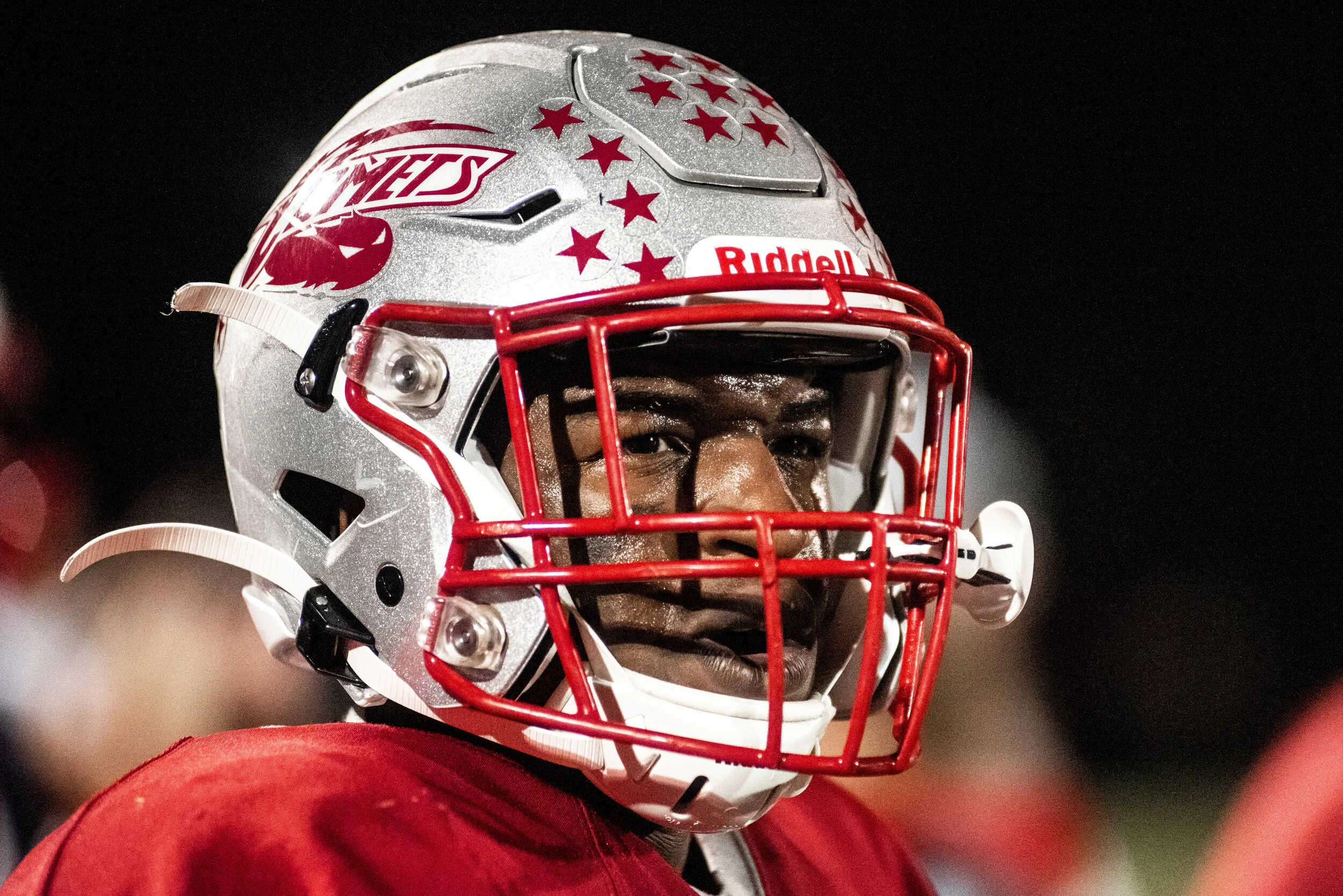 Carthage Football’s Fombo Azah looks out into the field from the sidelines of the homecoming game against Indian River in Carthage, NY.