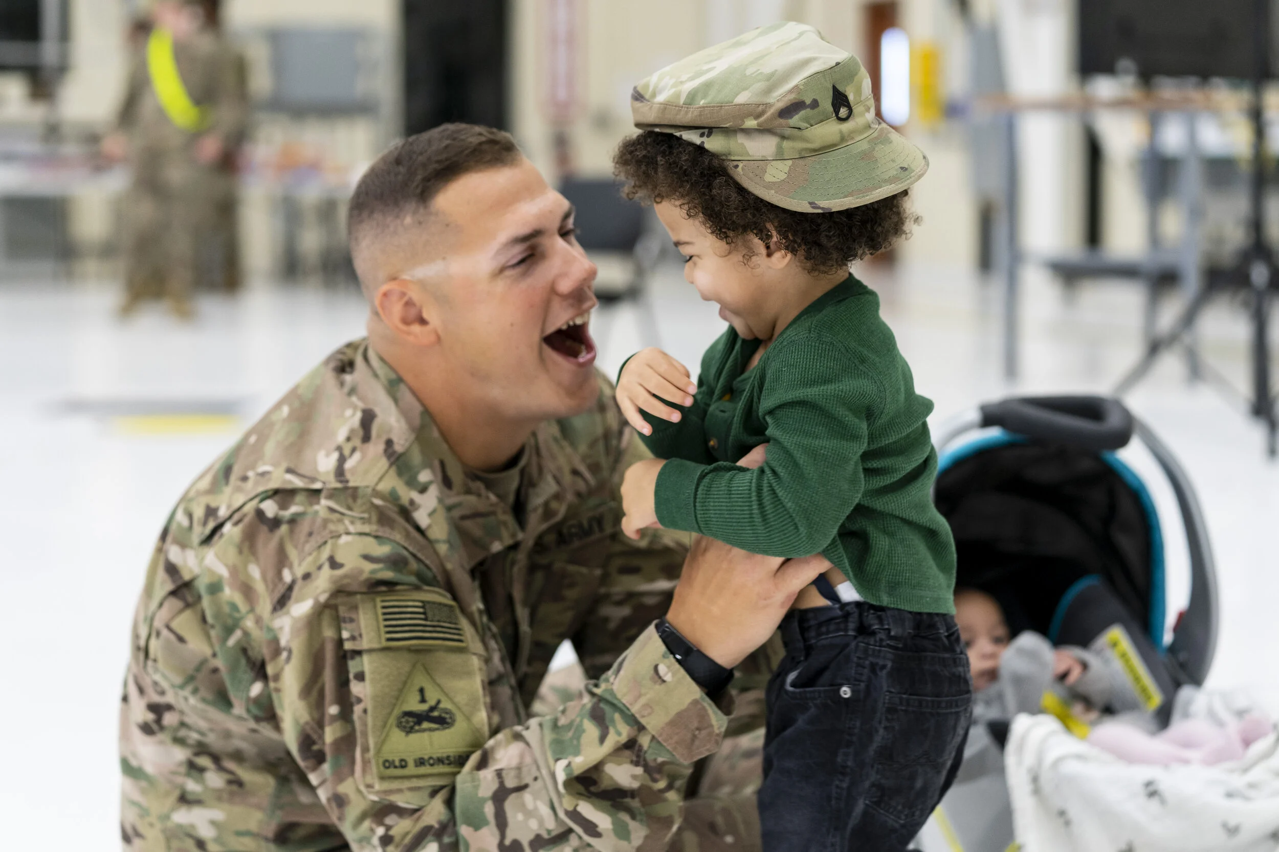 Arthur Butler, age 5, is reunited with his father Staff Sergeant Ben Butler at the homecoming event held for the D/10 “Gray Eagle” Company of the 10th Combat Aviation Brigade on Halloween in Fort Drum, NY. 
