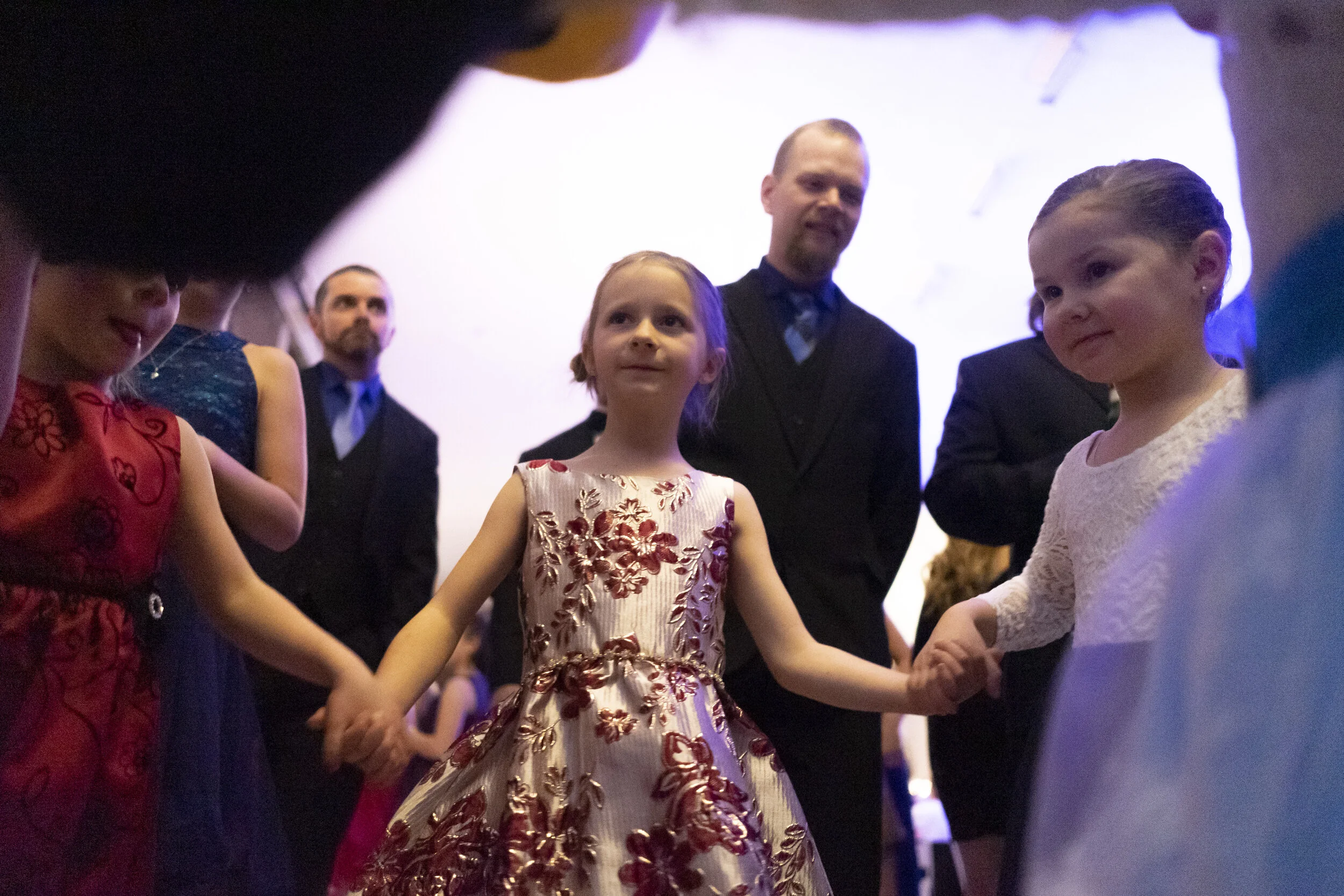  Three young ladies hold hands at the Sugarplum Ball, a father-daughter dance held annually in December as part of the Festival of the Trees in Watertown, NY.  