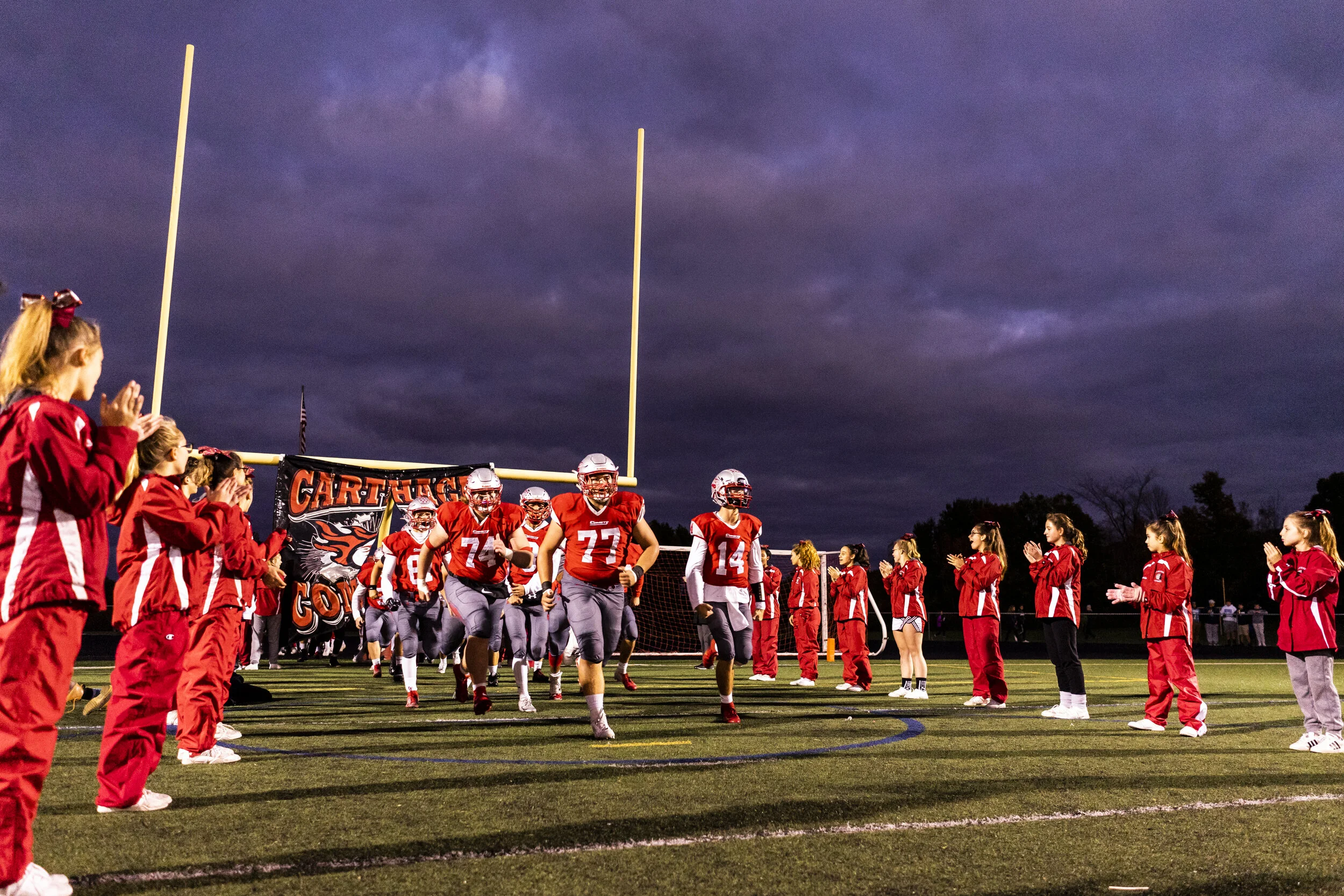  The Comets rush onto the field through the flanks of cheerleaders to face Indian River in Carthage, N.Y. on October 4, 2019. 