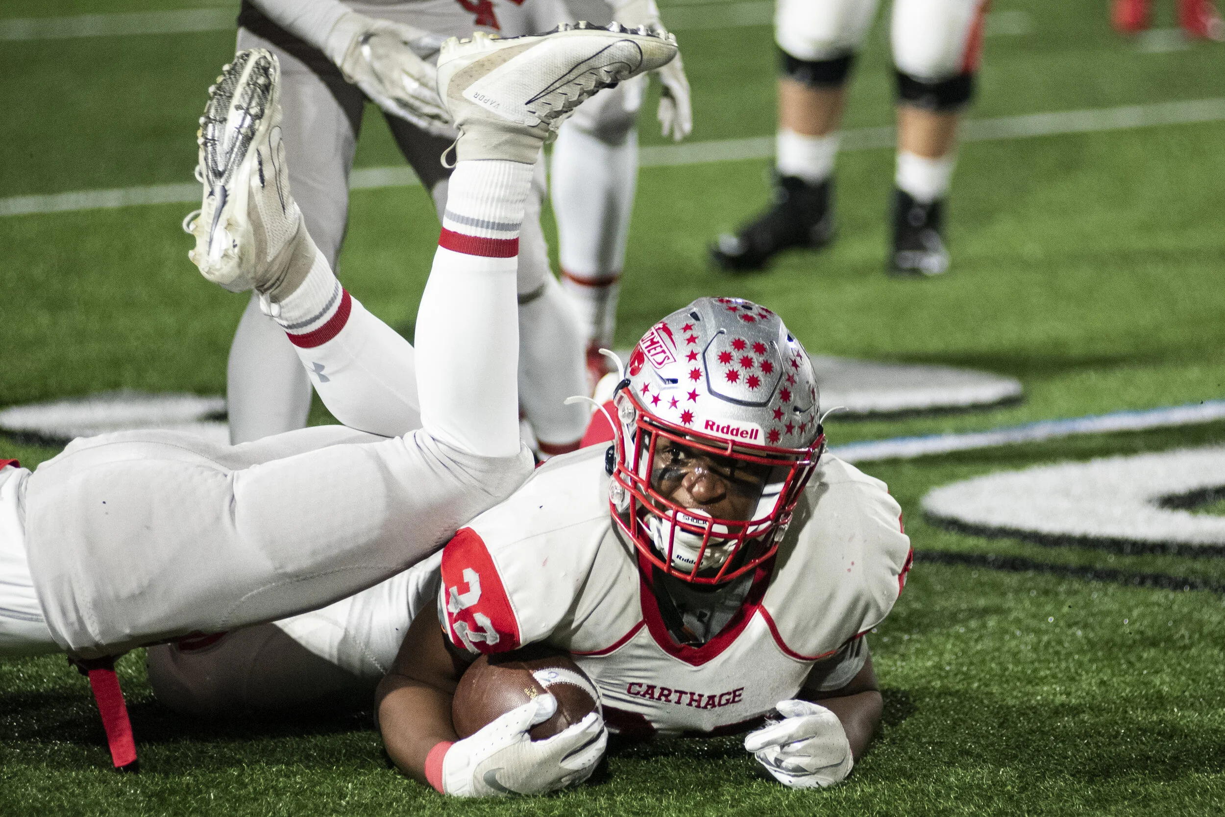  Fombo Azah holds onto the ball despite being tacked by a Canandigua defenseman in the state quarterfinal in Cicero, N.Y. on November 23, 2019. 
