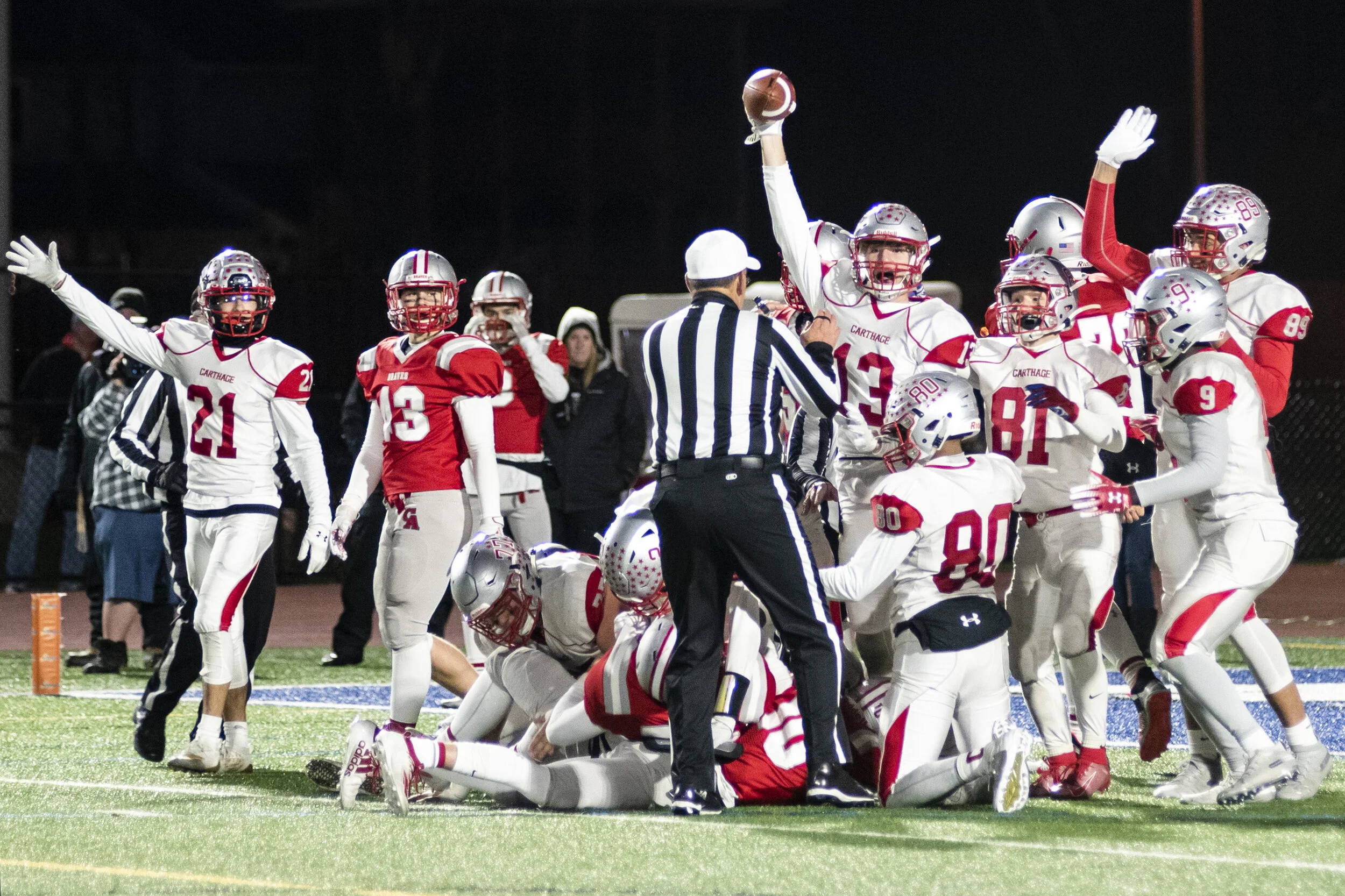  Thomas Albright triumphantly holds the ball above his head after recovering it in the last minutes of the game just before Canandigua scores in Cicero, N.Y. on November 23, 2019. 