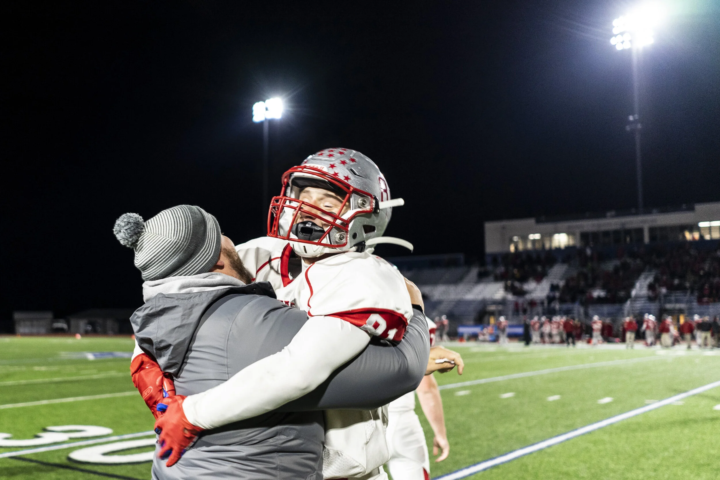  Carthage’s Ryan Gates celebrates with the coaching staff as the Comets’s clinch a spot in the state championship for the first time in program history. 