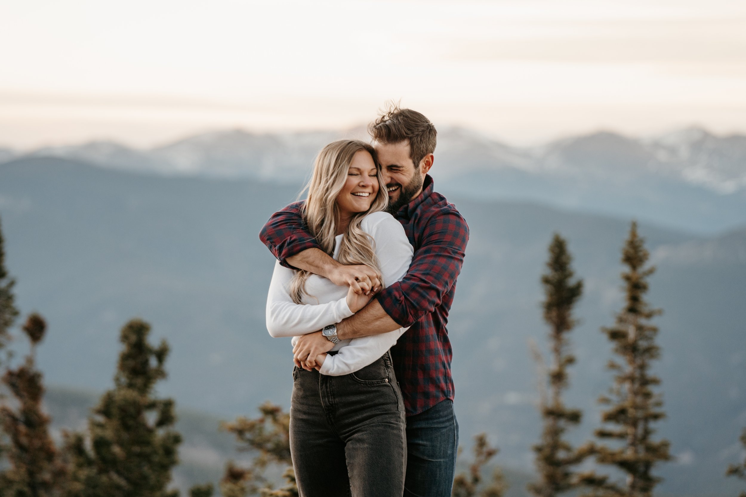 Engaged couple embracing in the mountains of Colorado