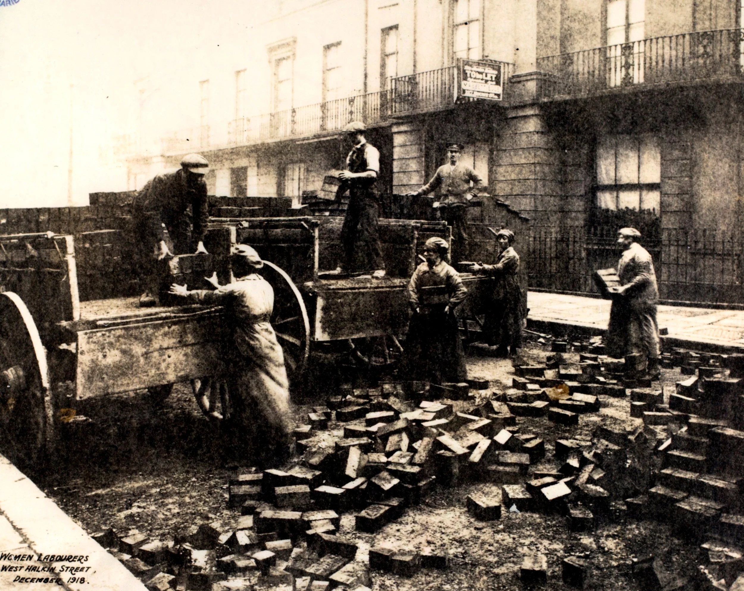 Women were employed in hard manual labour as well, seen here repaving streets in Pimlico.
