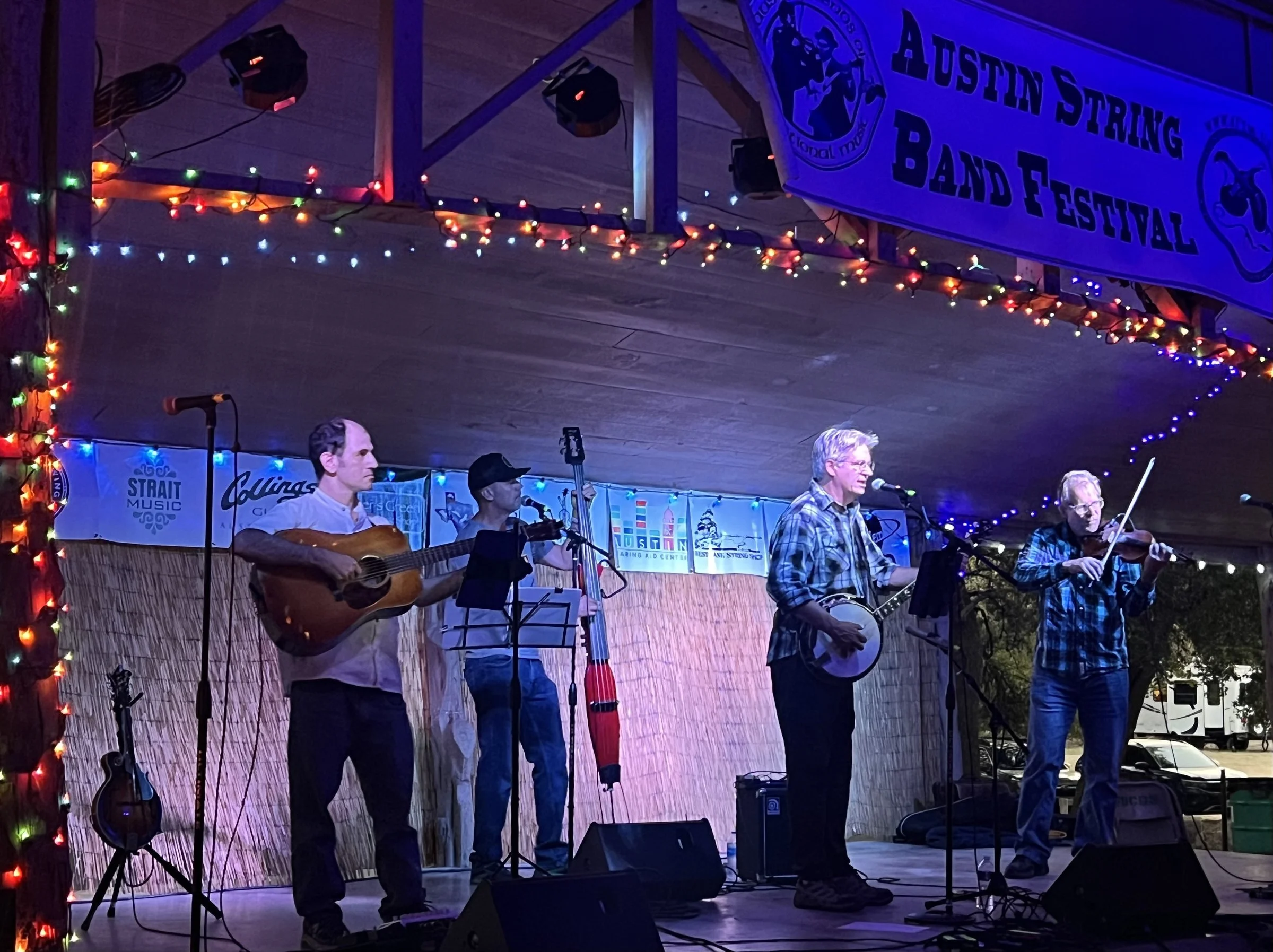 Hot Pickin 57s playing on stage at the Austin String Band Festival with red curtain and blue stage lights