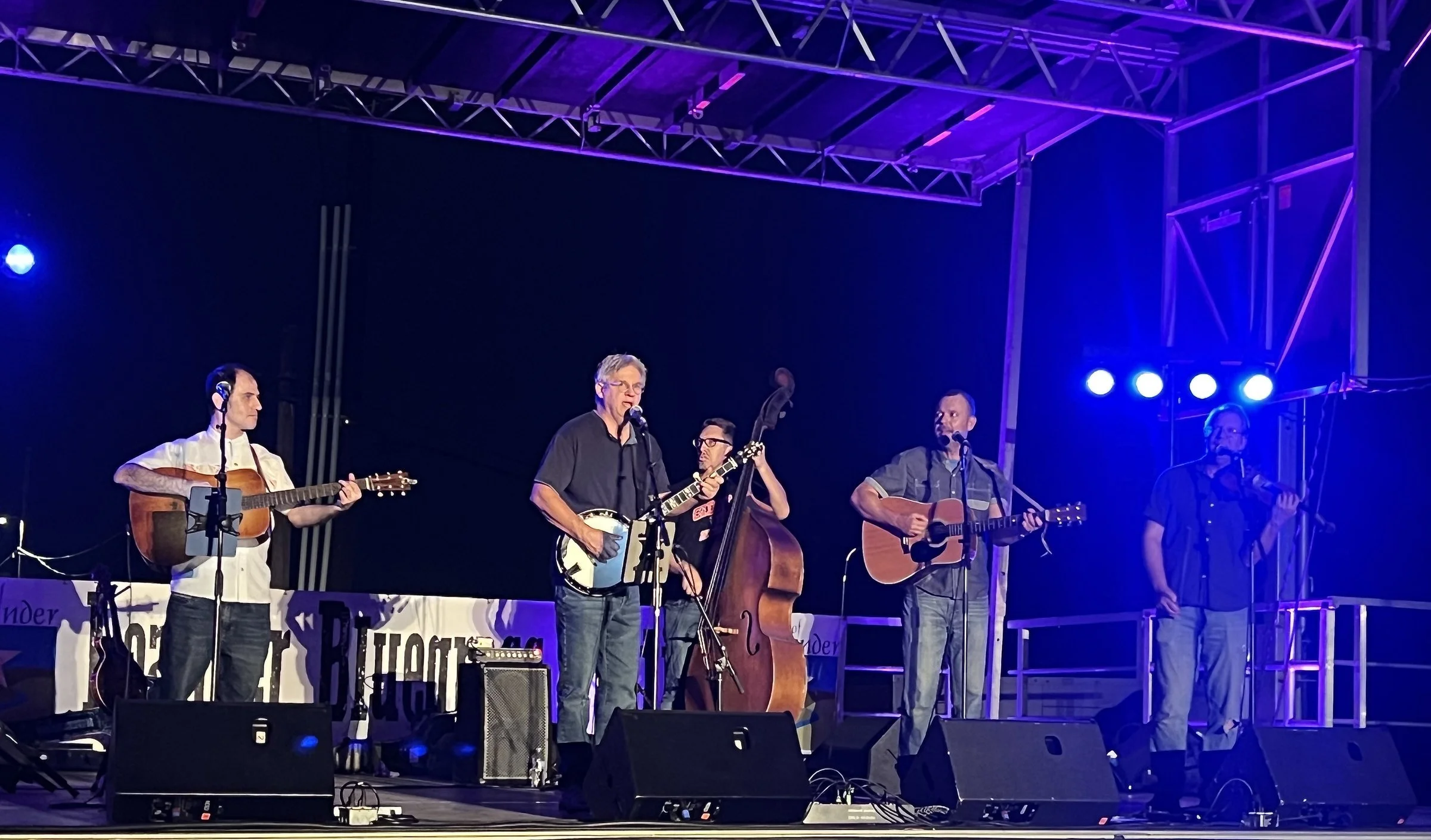 Hot Pickin 57s performing on a large festival stage at the Leander Bluegrass Festival with stage lighting and trusses