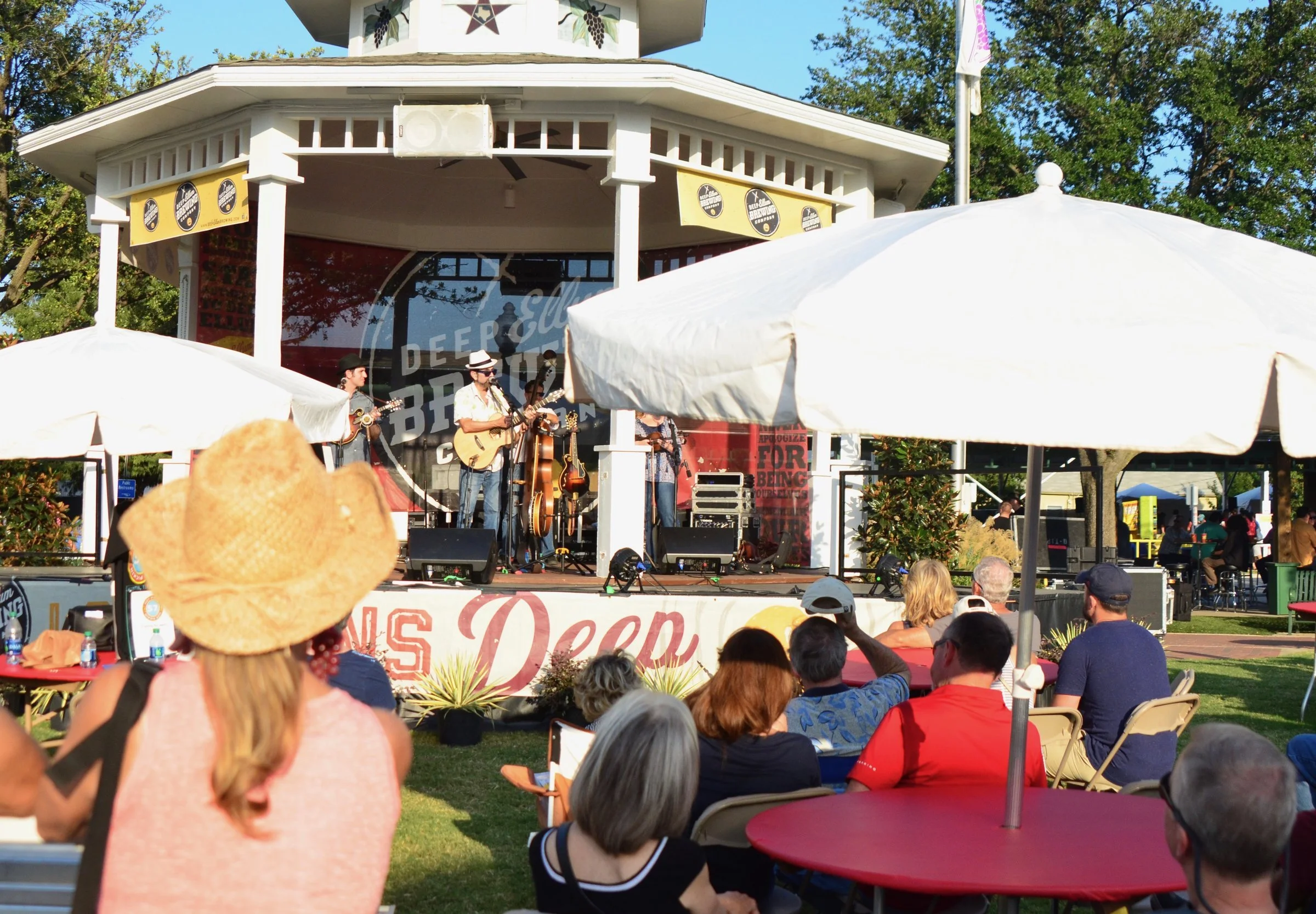 Hot Pickin 57s playing a gazebo stage at GrapeFest in Grapevine, Texas, with an outdoor audience seated under umbrellas