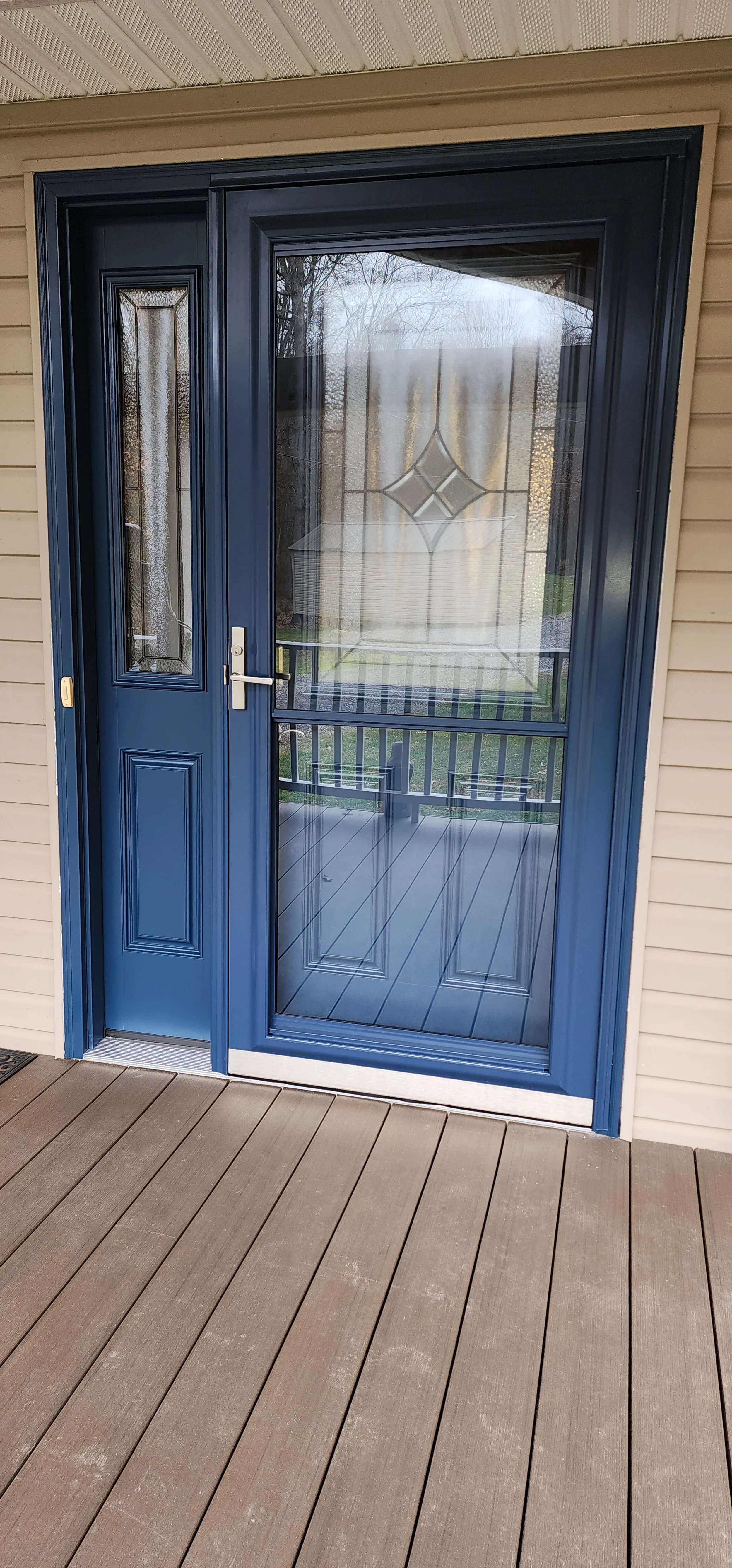ProVia Entry door system with matching storm door on Fusion Frame in Deep Waters