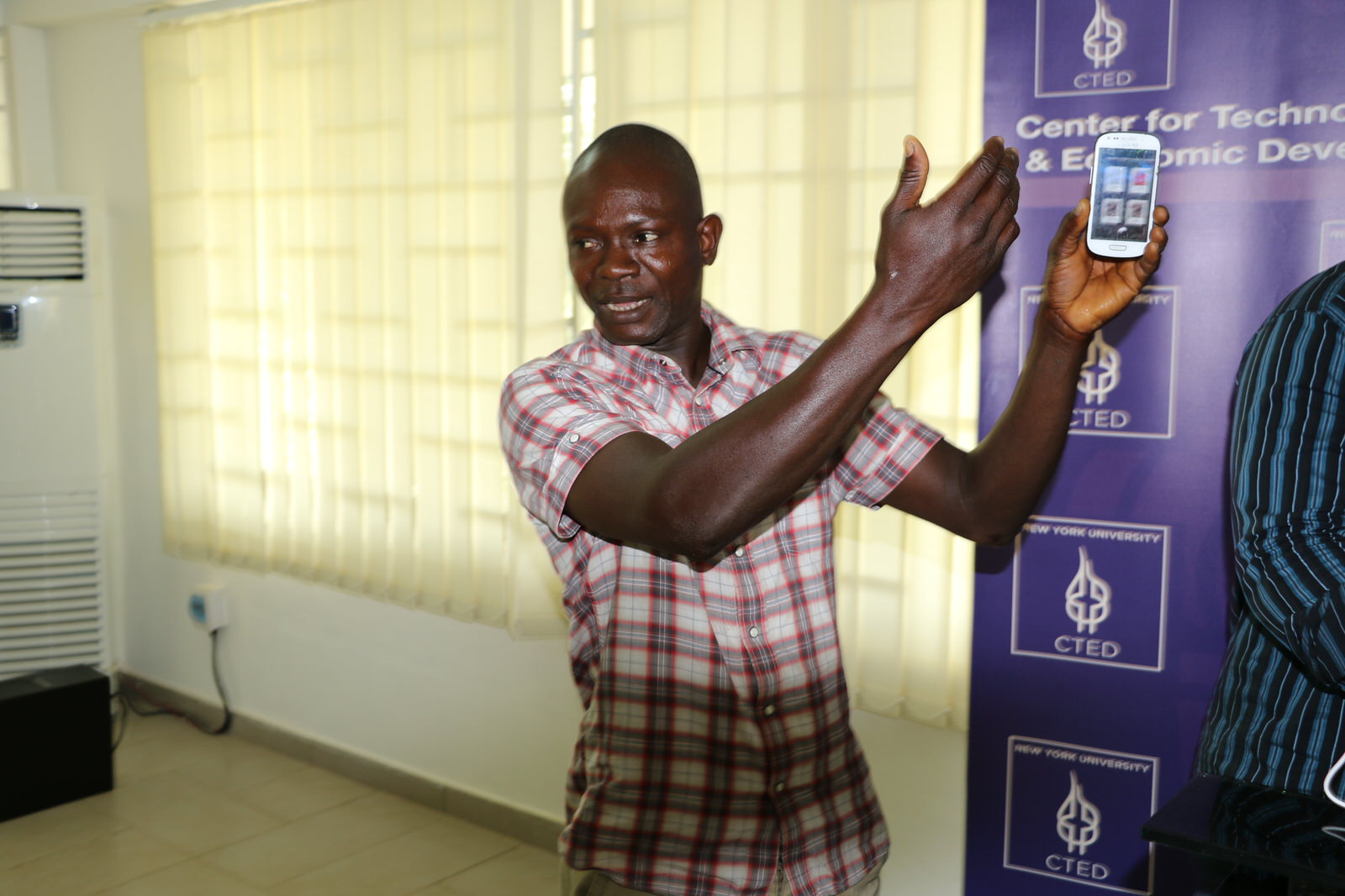 Farmer Demonstrating CTED-developed Mobile App