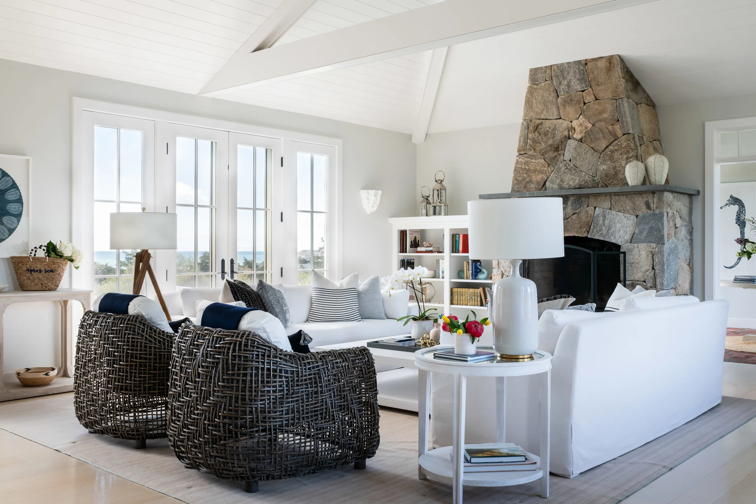 Living room: chairs, Palecek ; sofa, throws and pillows, Restoration Hardware ; floor and table lamps, Visual Comfort ; coffee table, Serena and Lilly . Design: James Studio Interiors // Photo: Jessica Delaney .