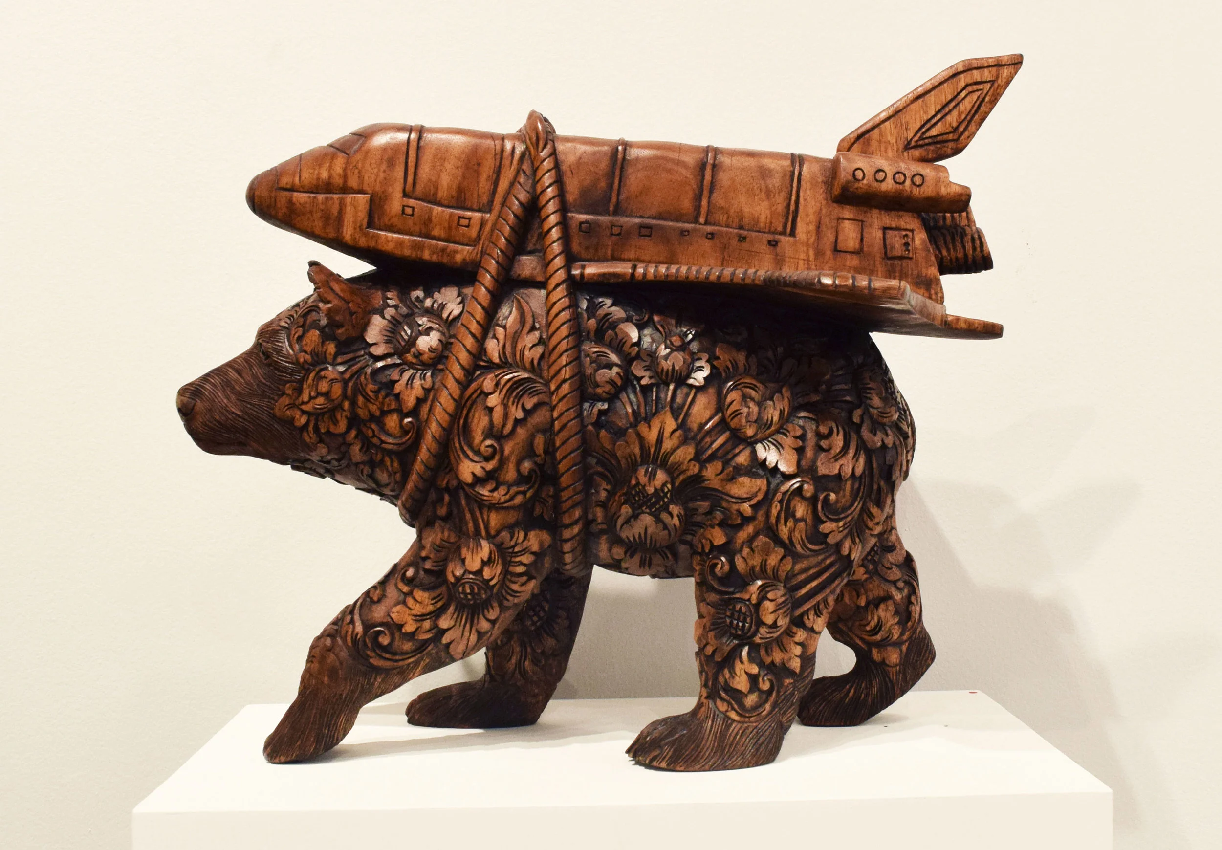 Carved wood, black wax, cosmic matter.