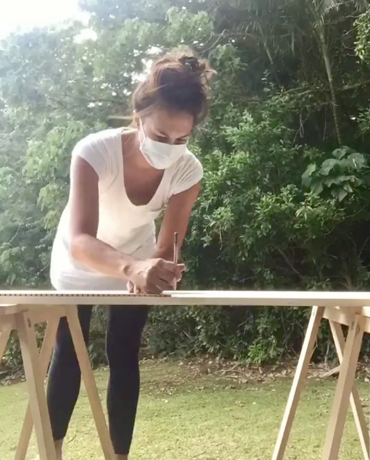Courtney listens while crafting eco-caskets in Oahu.