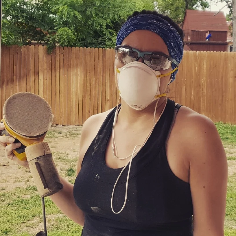 Amanda listens while refinishing chairs in Denver.