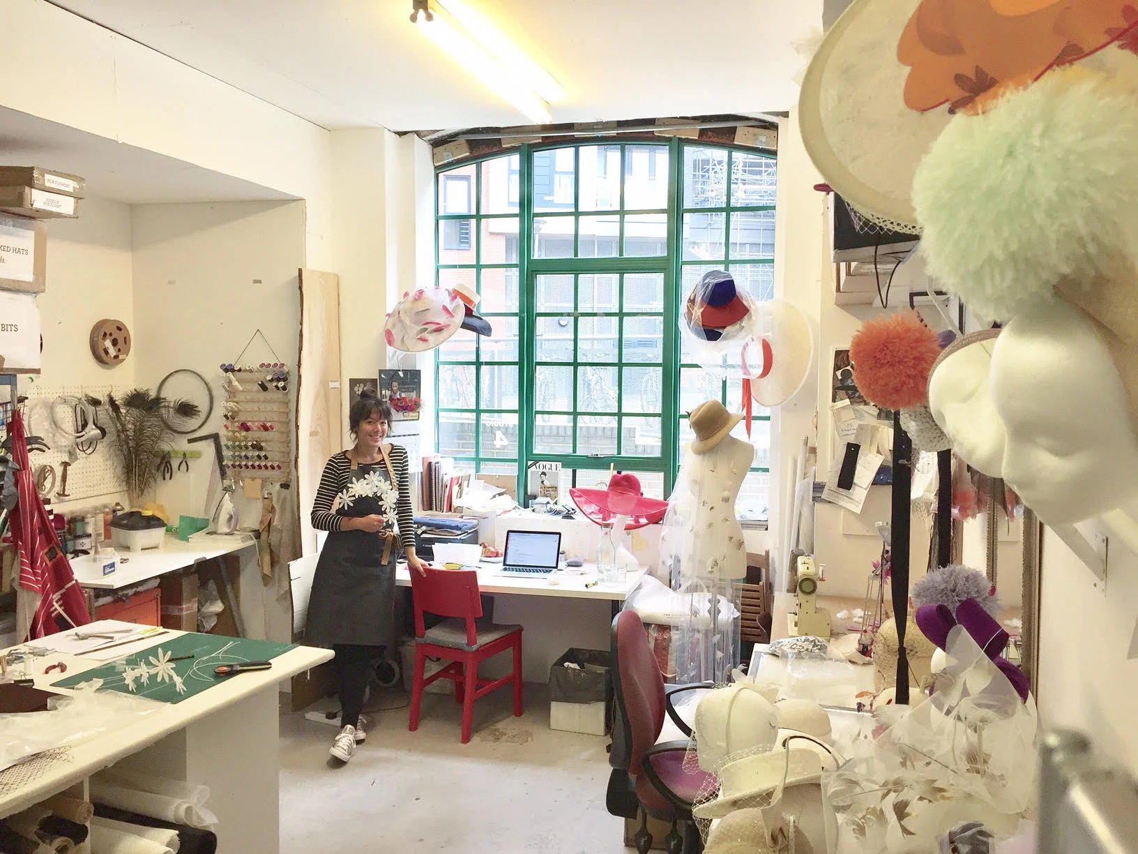 Awon from East London listens in her millinery studio.