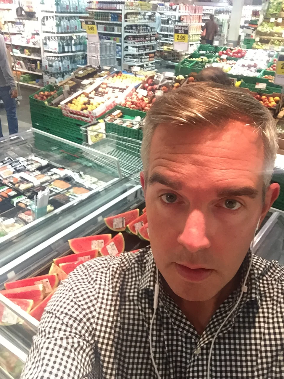  Ben listens in Geneva, Switzerland, while shopping for watermelon. 