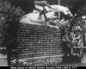 Kathy Kusner jumps Aberali in what appears to be an ordinary side-pull bitless bridle