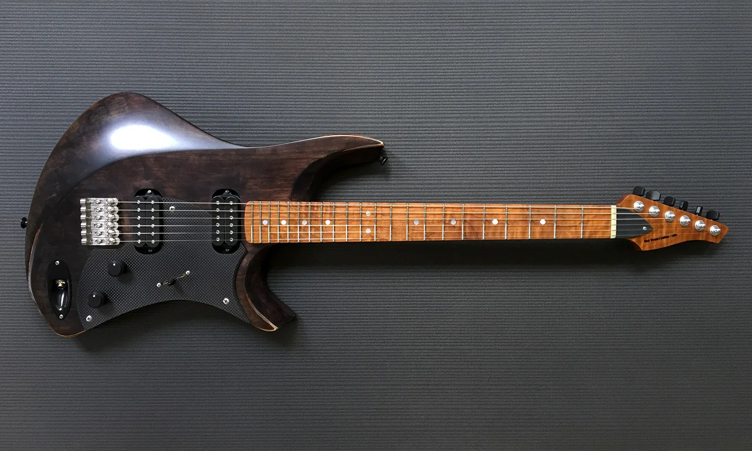 PHOTO: Intonation Cantilever™ precision machined stainless steel solo bridges, Carbon fiber pickguard, OEM DiMarzio pickups. Note jack location on this custom guitar.