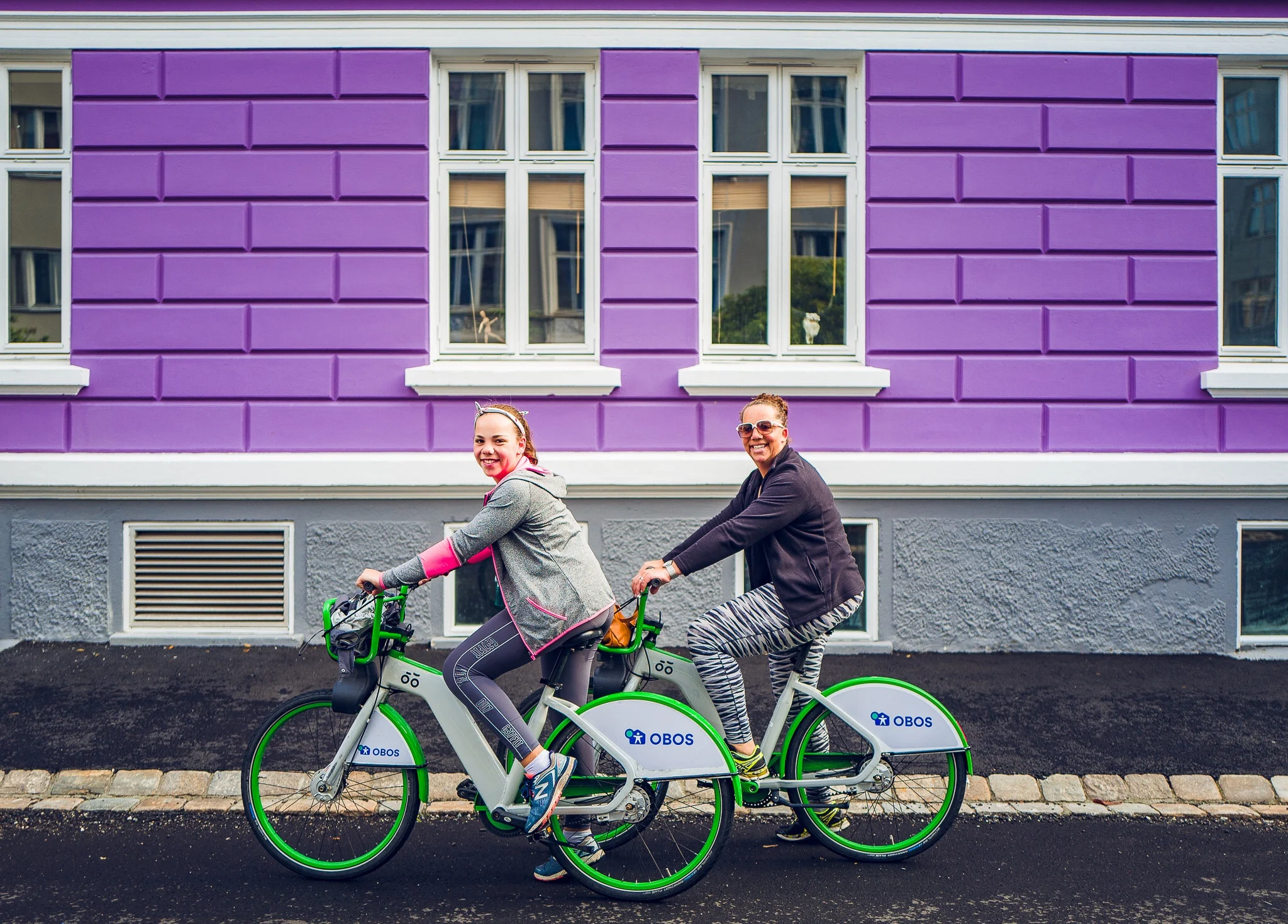 Today, we had a super local day in Bergen! We woke up quite early this morning, to find mum and dad on the phone to some friends. After breakfast, mum, Dad and I decided to venture out and explore the city of Bergen. We’ve been trying to rent bikes for the whole trip, but it’s never worked out, so this morning we installed the app, scanned the bikes from outside the apartment, and were off! We absolutely love the system; you pay 5 € for the whole day and can ride in 45 minute time chunks. The bikes are bright green, and have a spot for the phone to do GPS! The system’s way better than Sydney because there are special docks everywhere, where you have to return the bikes instead of being able to leave them on the footpath wherever you like. The town is also super bike friendly, and there are bike paths, and ramps everywhere. We rode around the back streets, and discovered the city. We stopped at a lovely local bakery for hot chocolate and chai lattes and shared an amazingly soft skillingsboller (a local Norwegian pastry like a cinnamon scroll). At the bakery, we then picked up a loaf of local bread for lunch. We arrived back to the apartment to Audrey and Polly. We then had a GLunch (Glee Lunch) of fresh bread, smoked salmon, cream cheese, salami, etc. After a small amount of downtime, we decided to drive to the local swimming pool, the Nordnes seawater pool. The view from the pool was beautiful! The pool water was heated to 25 degrees but still felt quite cold. Mum, Polly and I went in the sauna to warm up, Audrey went in the small kiddie pool and Ben jumped into the Fjord which was a freezing 12 degrees. We got home around 5pm. We all showered and got settled for the night. Then, I realised that I needed to head to a shop downtown to change the letters from my message board because some of them were missing. The shop closed at 6:00pm, so mum agreed to quickly ride the bikes there. We both rented bikes, and rode 15 minutes downtown to the store, only to arrive 15 min before closing time. We got hooted at twice because we went through quite a few red lights, and I almost rode into a crane and did go head first into a wall, but we made it! I swapped my purchase, and I helped mum pick out some gorgeous earrings for her birthday. We rode back, and met dad & Audrey in the park near our apartment, as there was the Bergen Philharmonic Orchestra playing in the park. There were at least 200 musicians, and 1000s of people having picnics on the grass. We sat on towels, and watched for a while before heading home to Polly for our 9pm dinner of supermarket snacks and GLEE. Lovely local day and lots of time today with mum ;-). Off to Paris tomorrow…Yippee!!!