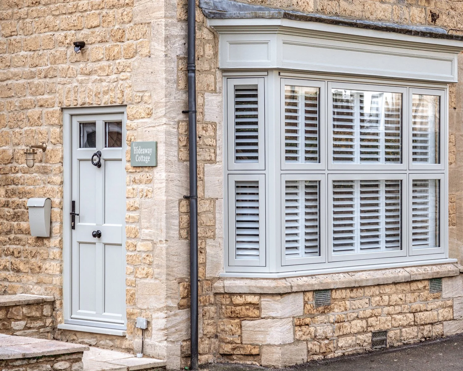 The exterior view of Hideaway Cottage, which has a past life as a bookmakers, a boot shop, and Collett's Garage