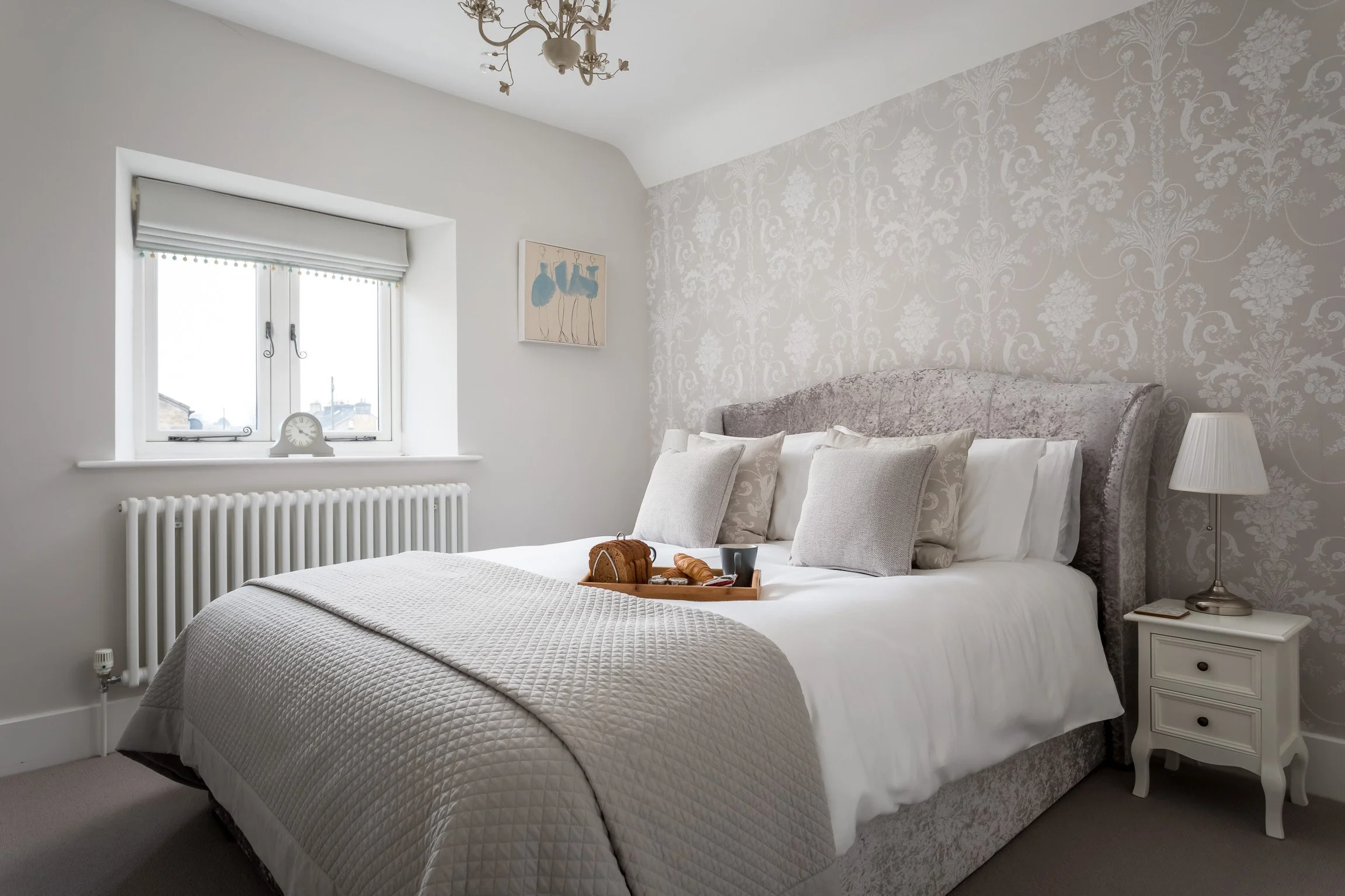 A bright and beautifully decorated bedroom at Little Gem Cottage in Bourton-on-the-Water, featuring a king-size bed and elegant furnishings