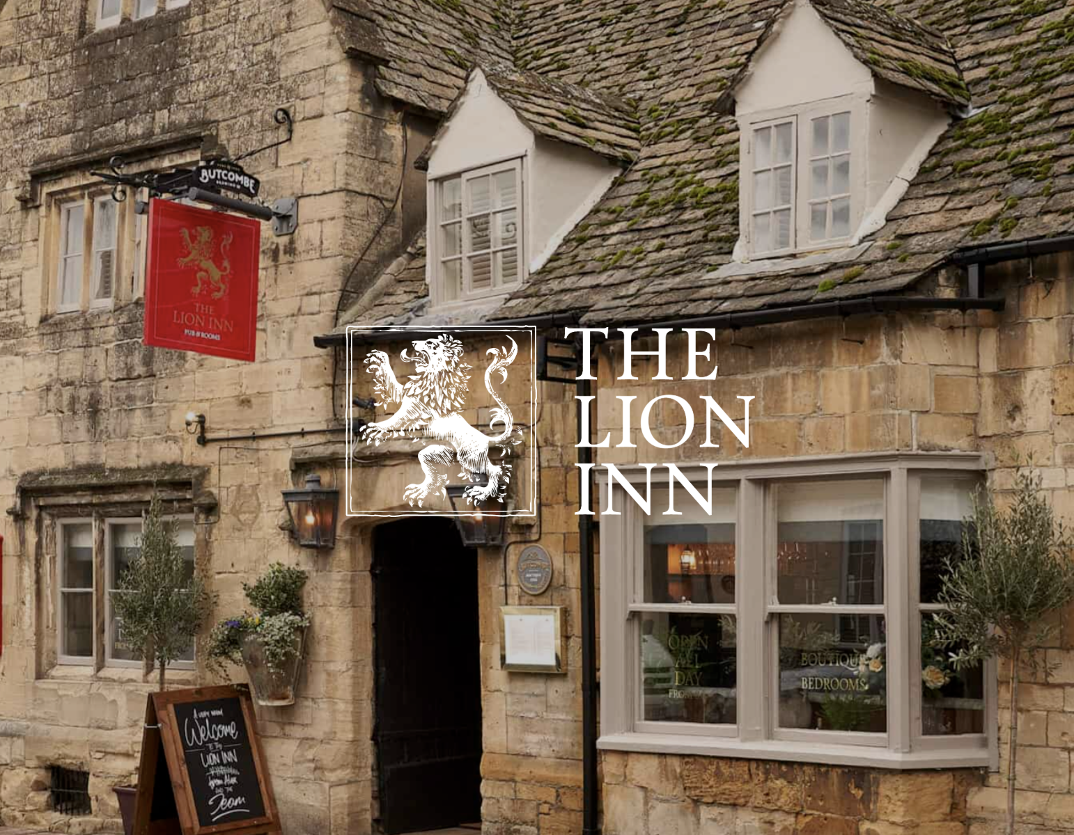The exterior of The Lion Inn in Winchcombe, a traditional stone pub that welcomes dogs with treats and water bowls