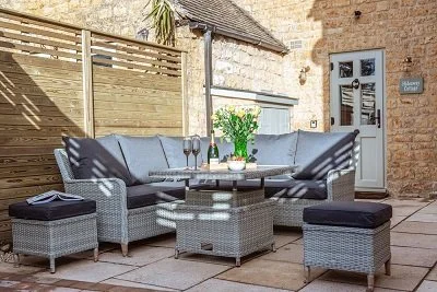 Comfortable and stylish Bramblecrest garden furniture set arranged on the patio at Hideaway Cottage, perfect for outdoor dining and relaxation