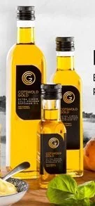 Bottles of high-quality, cold-pressed Cotswold Gold rapeseed oil, locally produced on a family farm in the heart of the Cotswolds