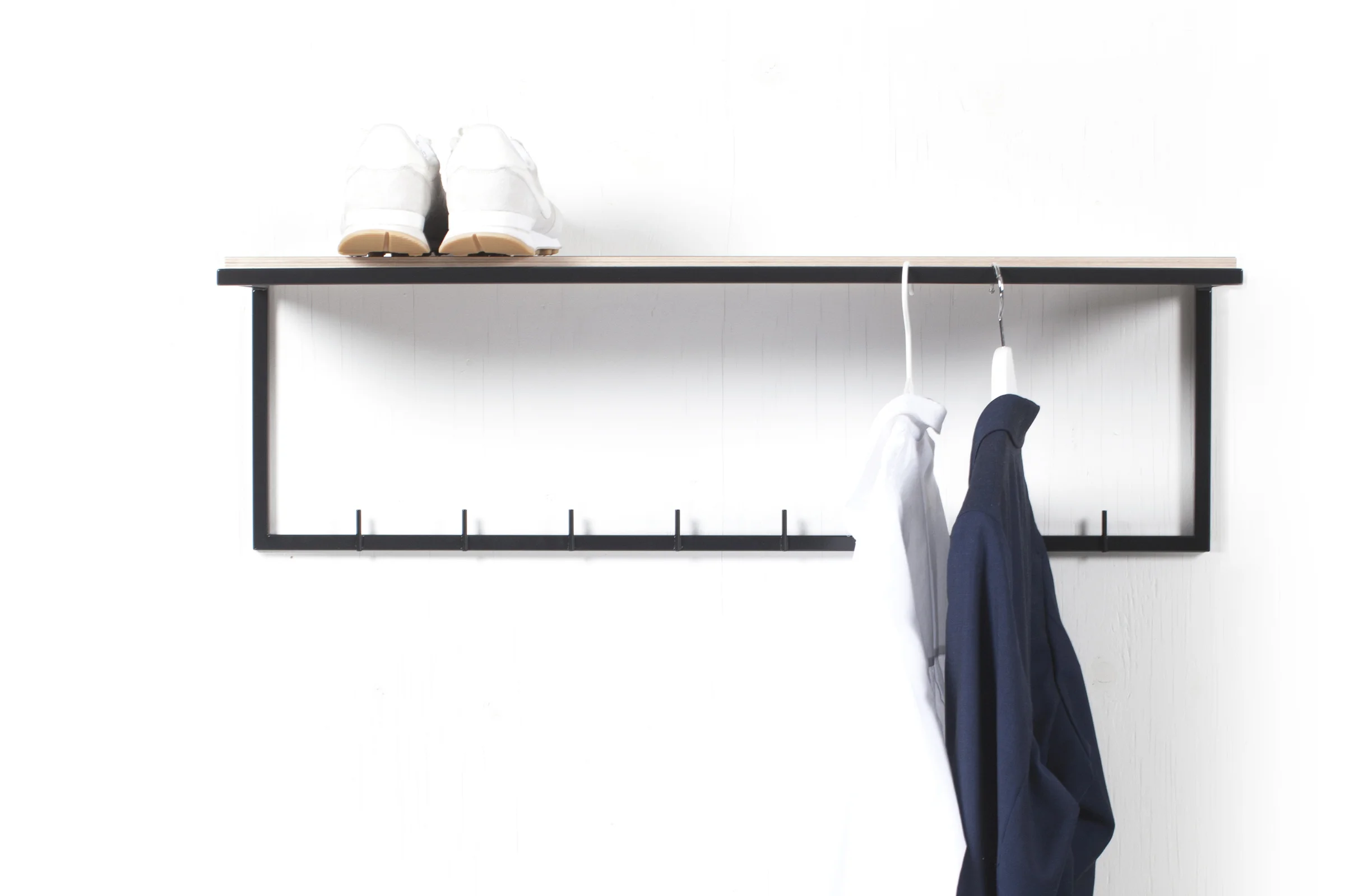 mllmtr_shop image 04_L1-900 BLACK_wall mounted clothes rack_front_shelf_white sneakers_blue blazer.jpg