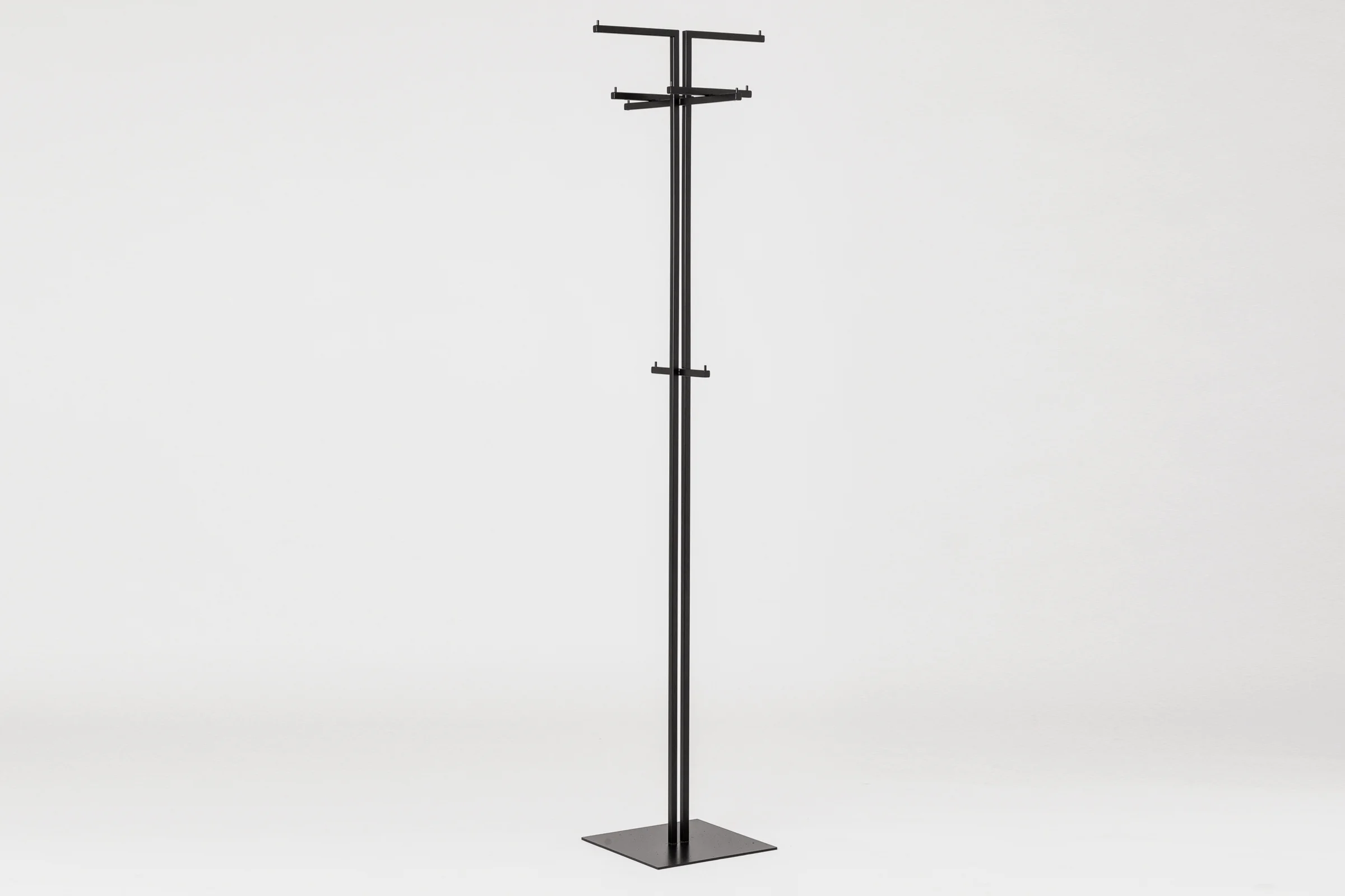 mllmtr_shop image 02_L3 BLACK_clothes stand_front side view_GREY BACKGROUND.jpg
