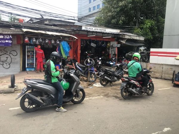 Go-Jek workers riding their unicorns through the streets of Jakarta.
