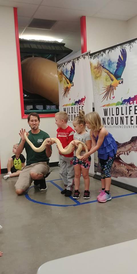 Kids holding snake